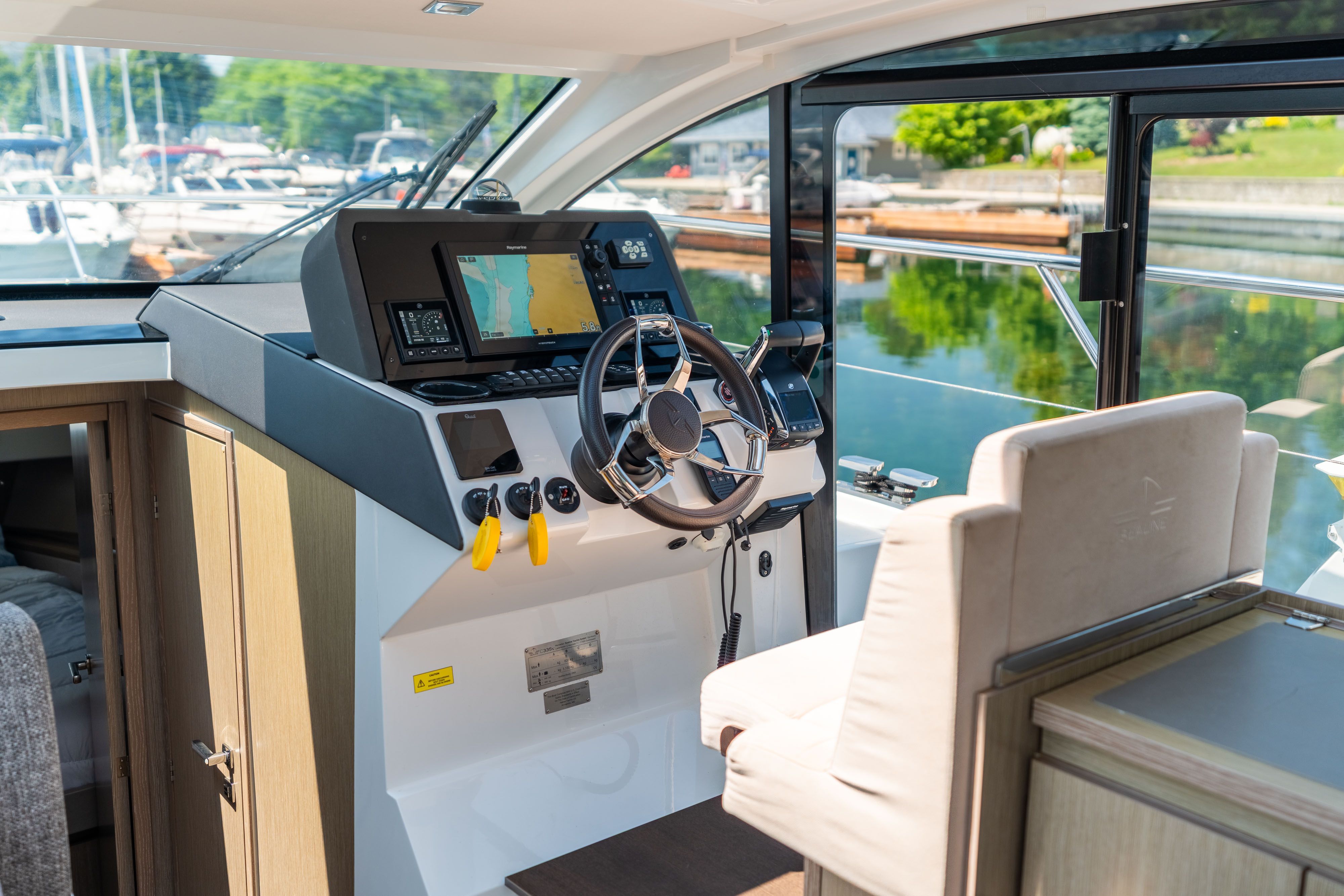 The 2023 Sealine C335V cockpit features a modern helm with navigation system.