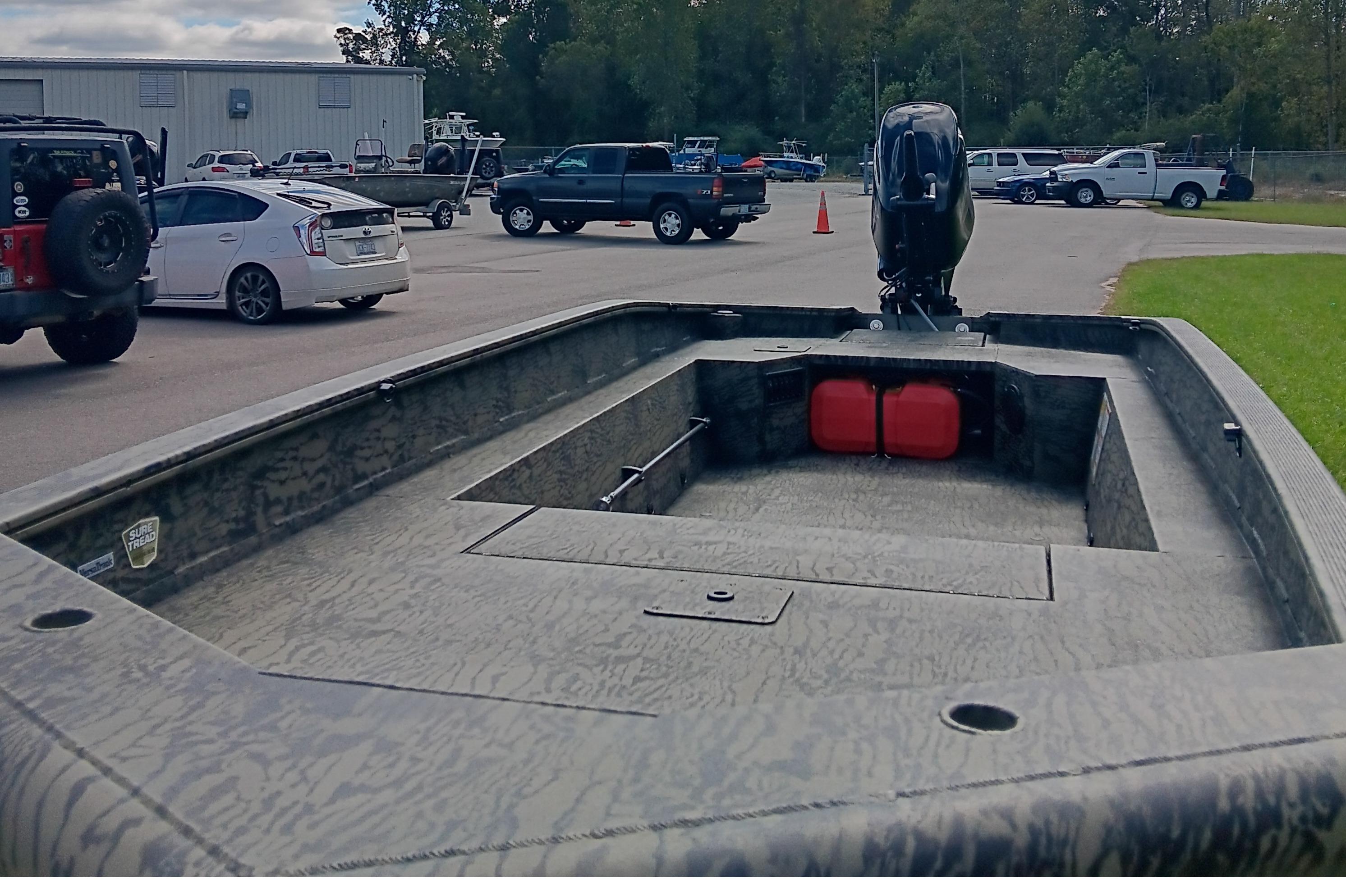 2026 Tracker Grizzly 1650 T Prairie Wings Edition boat in parking lot.