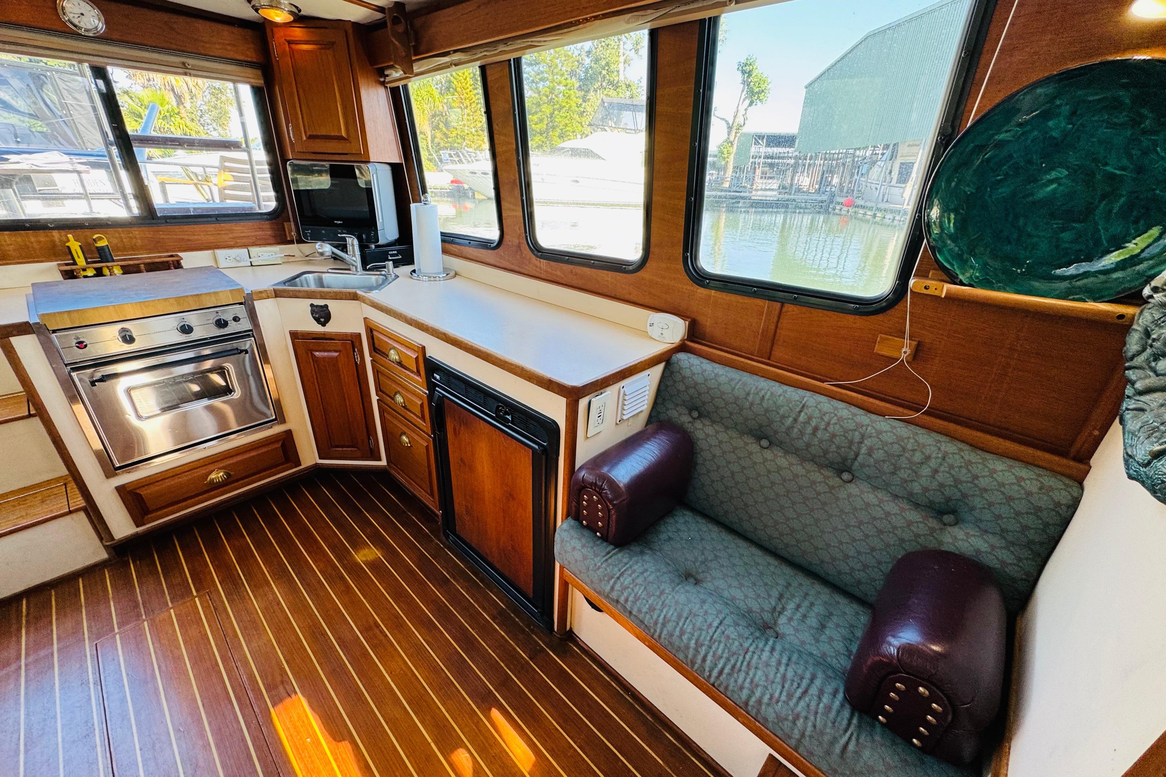 Interior of a Nordic Tug 32 with kitchen and seating area.