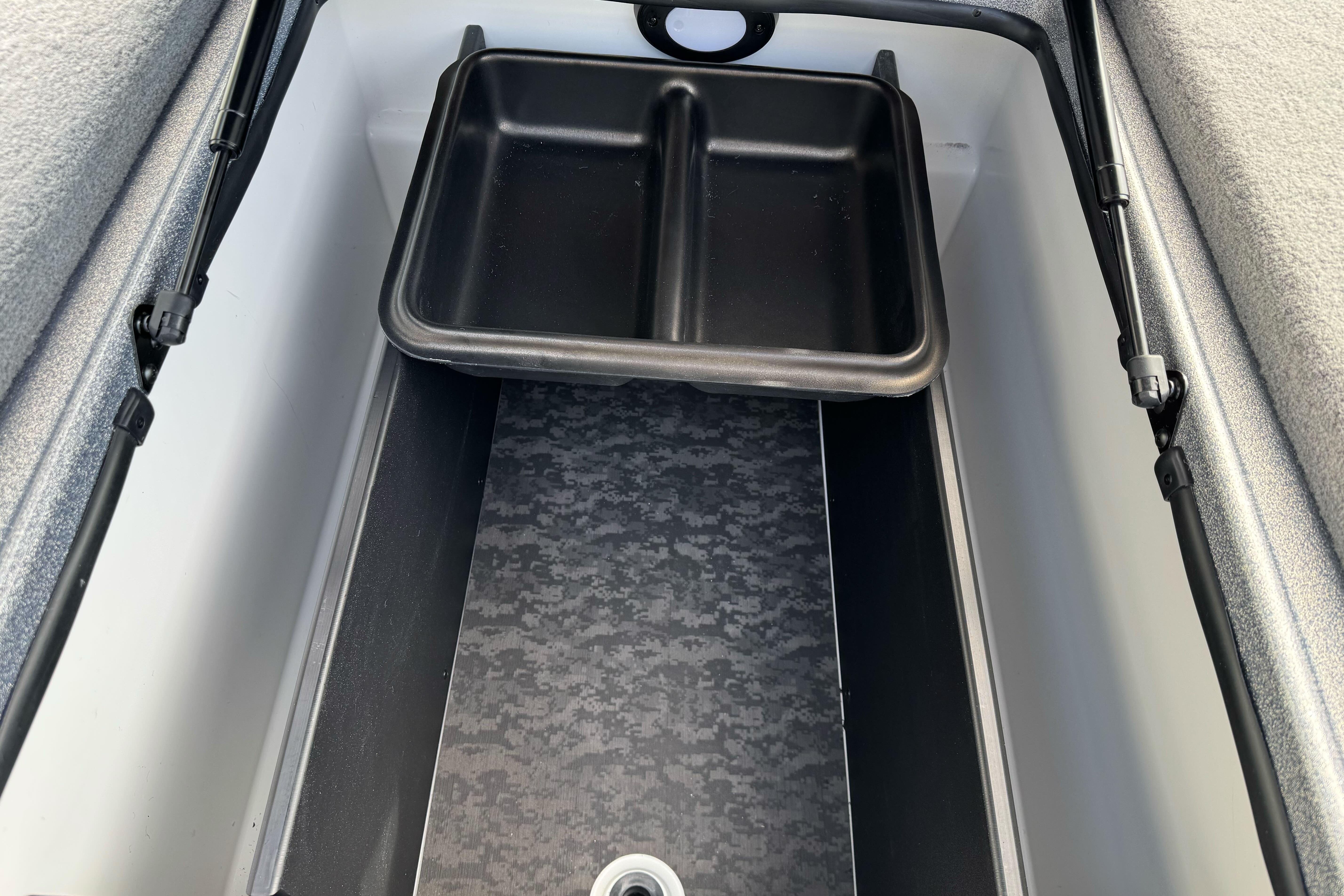 Storage compartment of 2026 Nitro Z19 XL boat with black tray and patterned interior.