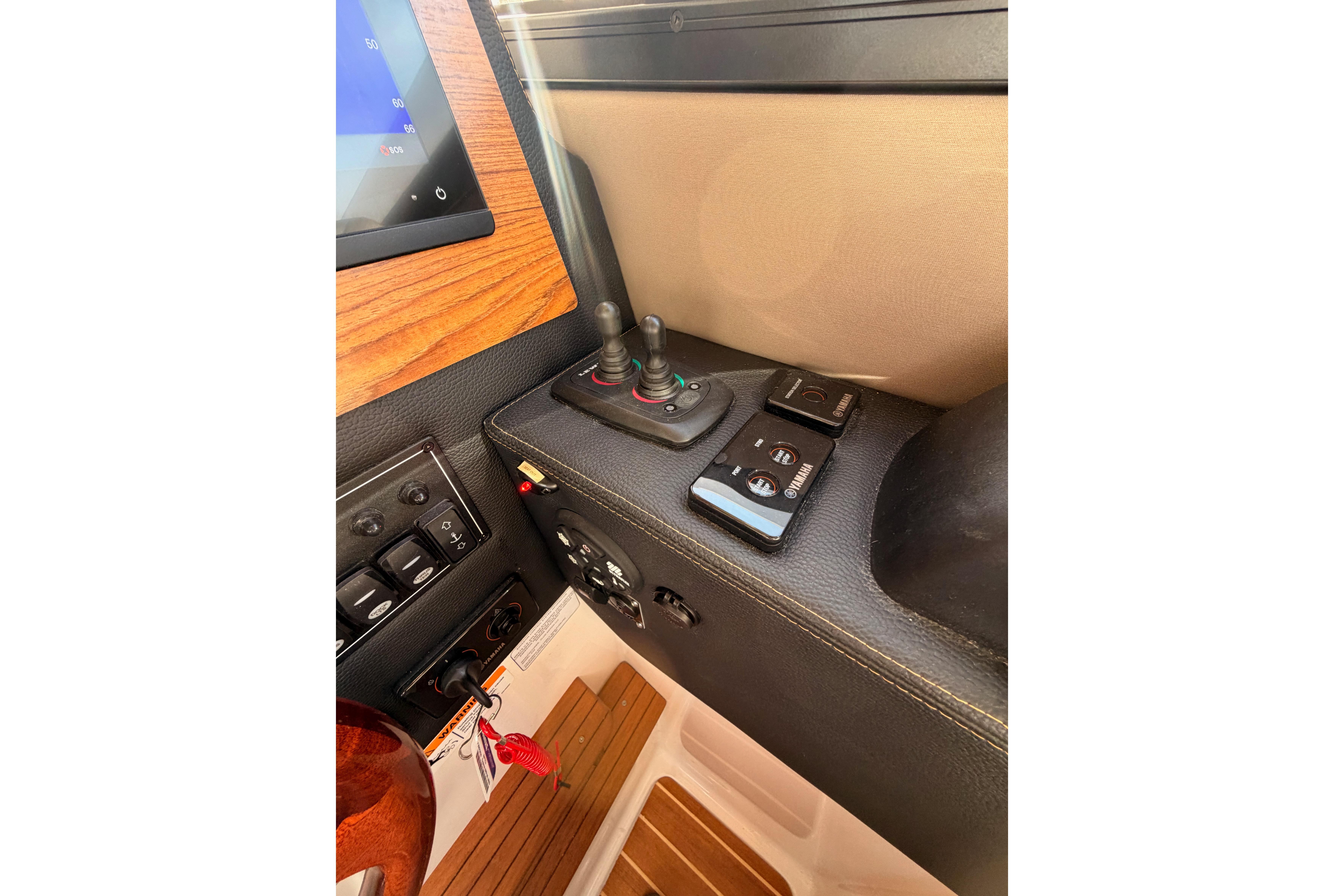 Control panel of 2021 Cutwater C-32 CB boat with joystick and switches.