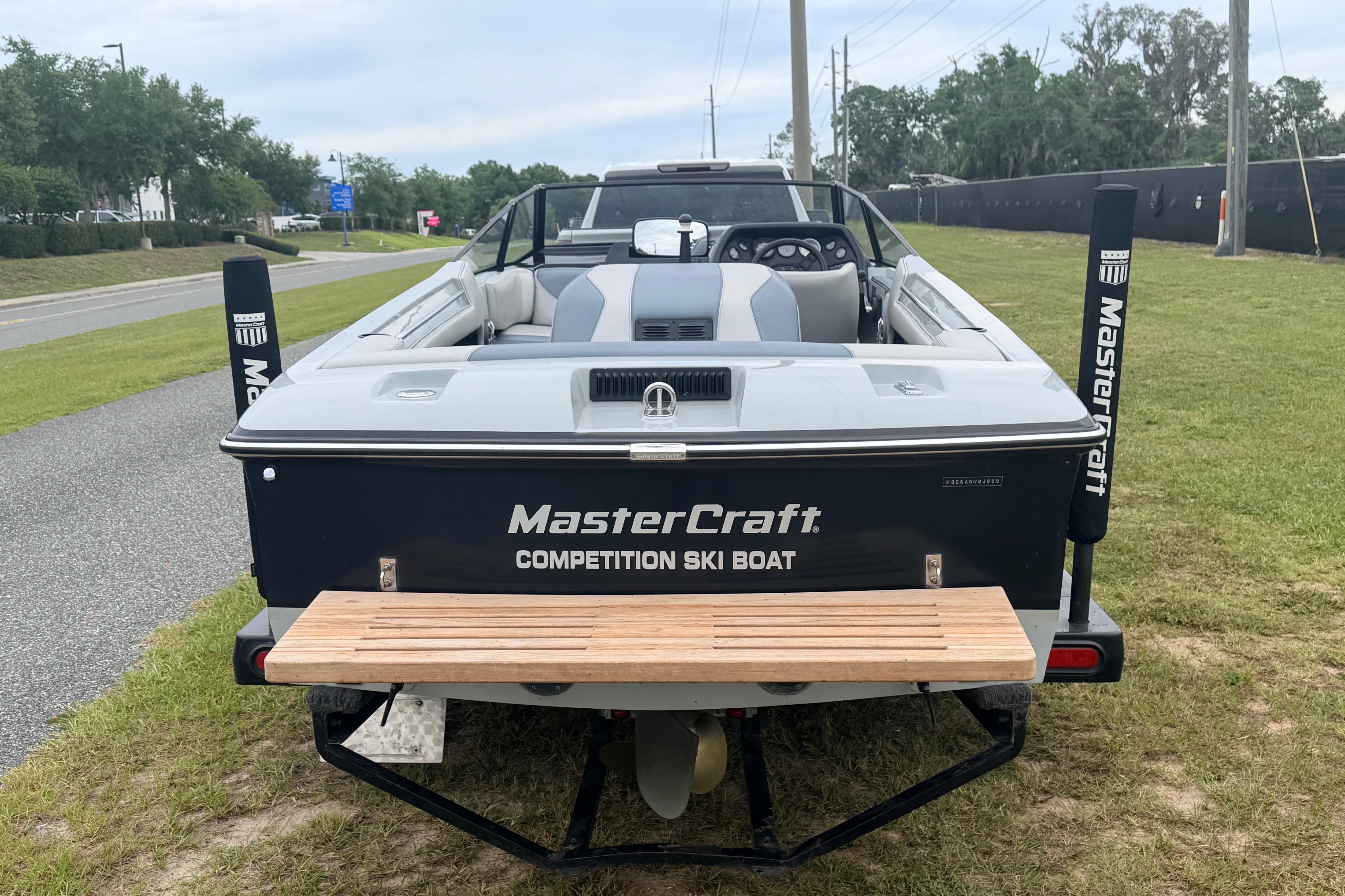 1989 MasterCraft ProStar 190 competition ski boat on grass, rear view.