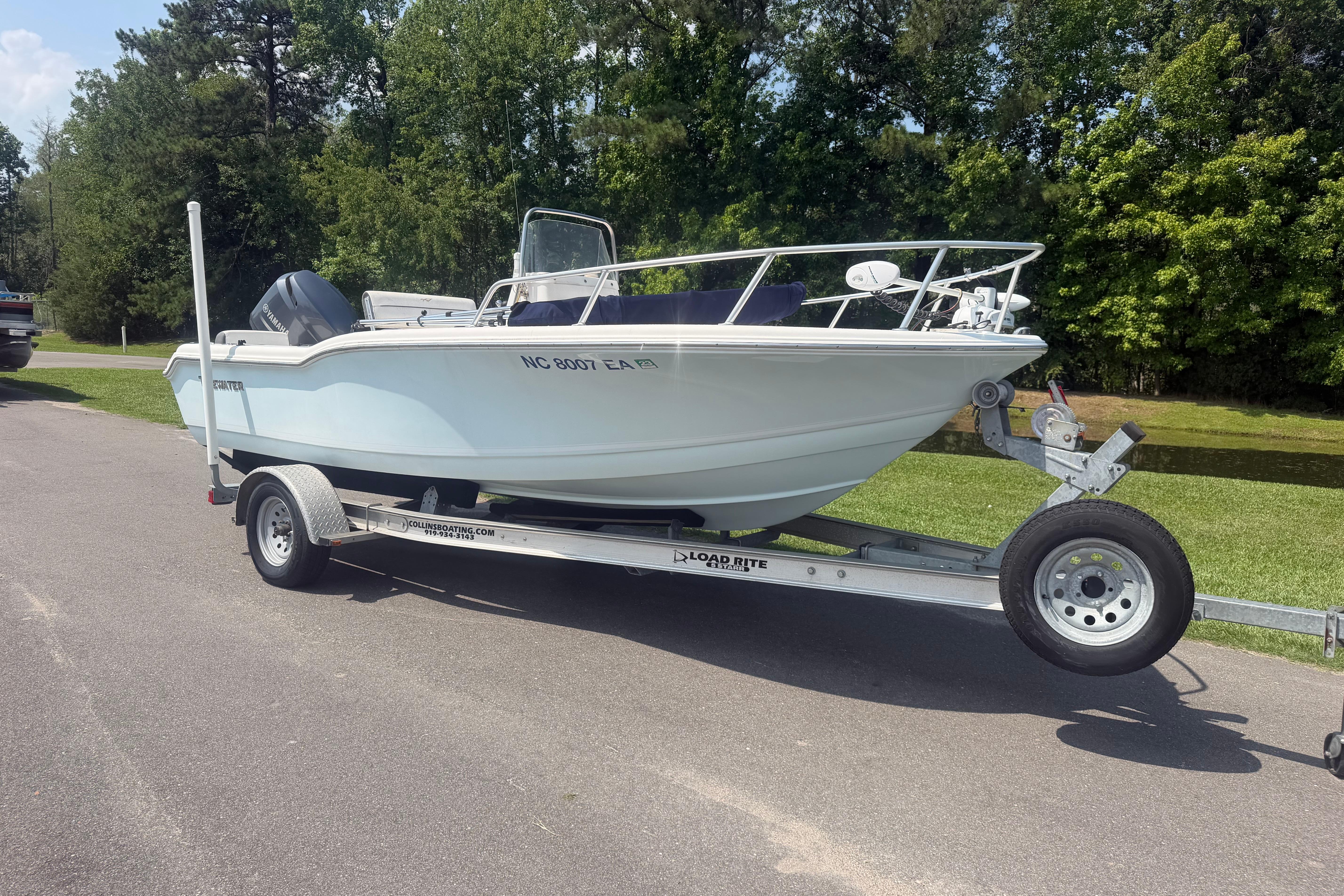 2015 Tidewater 180 CC Adventure boat on trailer, parked on a sunny day.