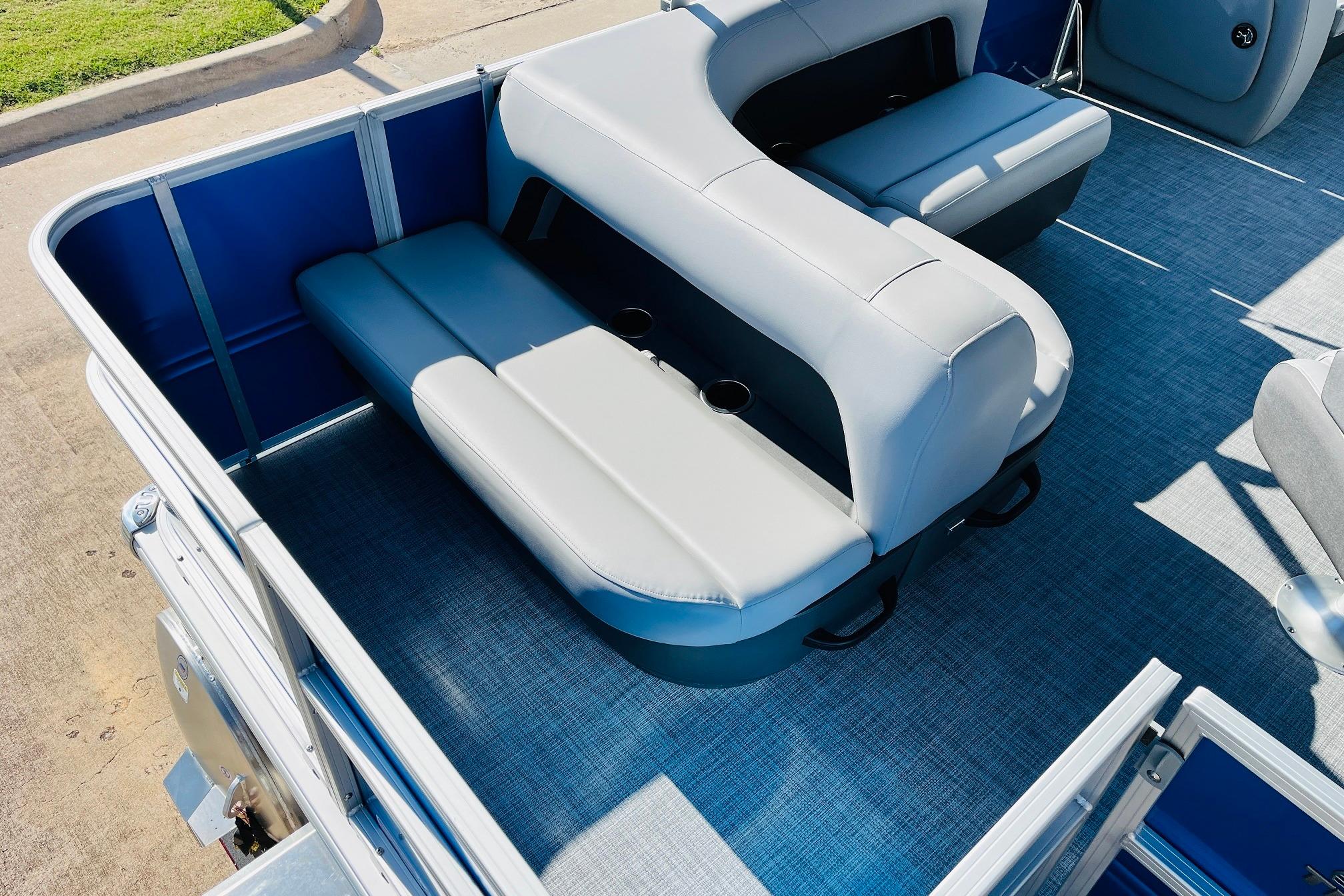 2026 Sun Tracker Party Barge 18 DLX interior with gray seating and blue accents.