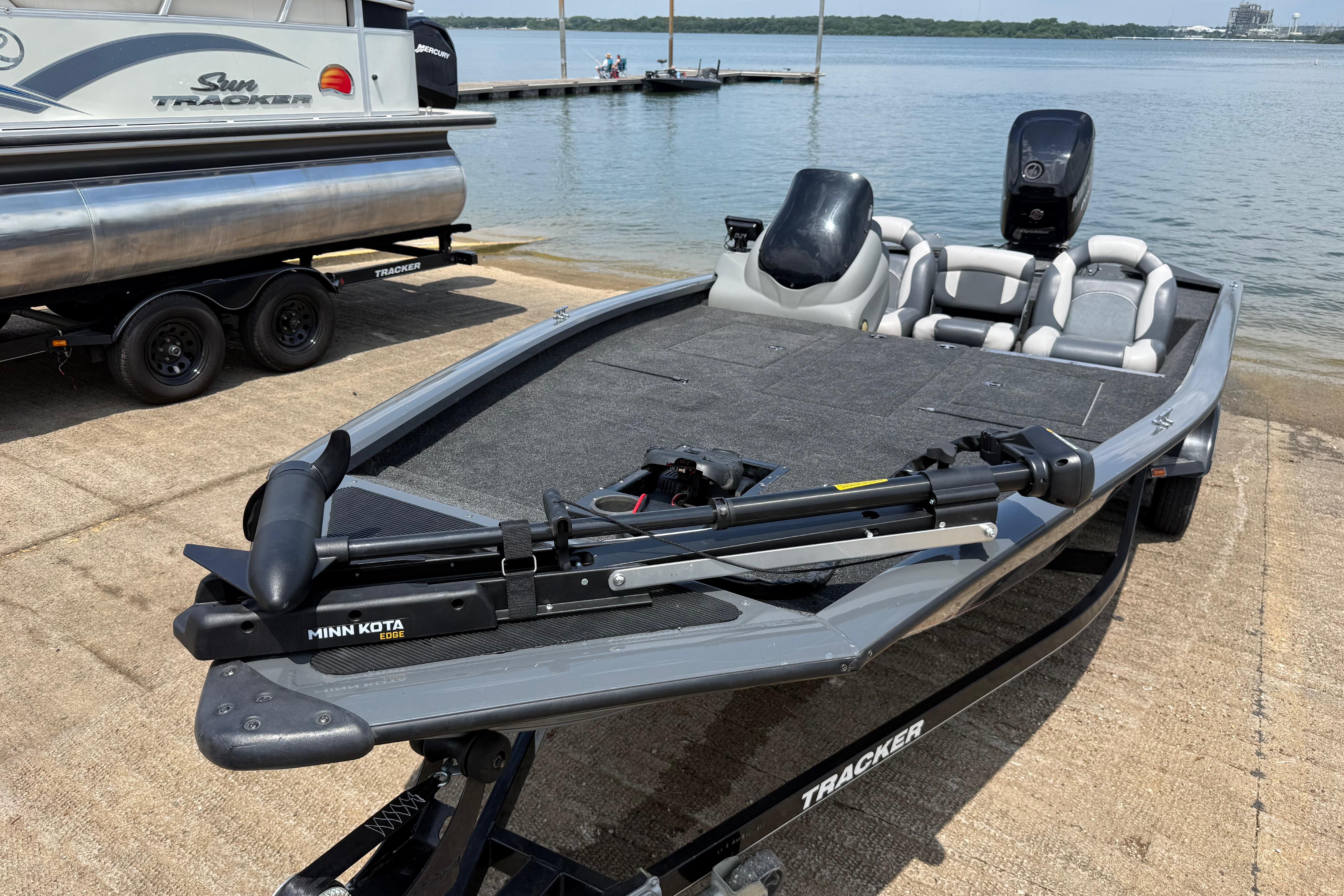 2015 Tracker Pro Team 190 TX fishing boat with Minn Kota motor at lakeside dock.