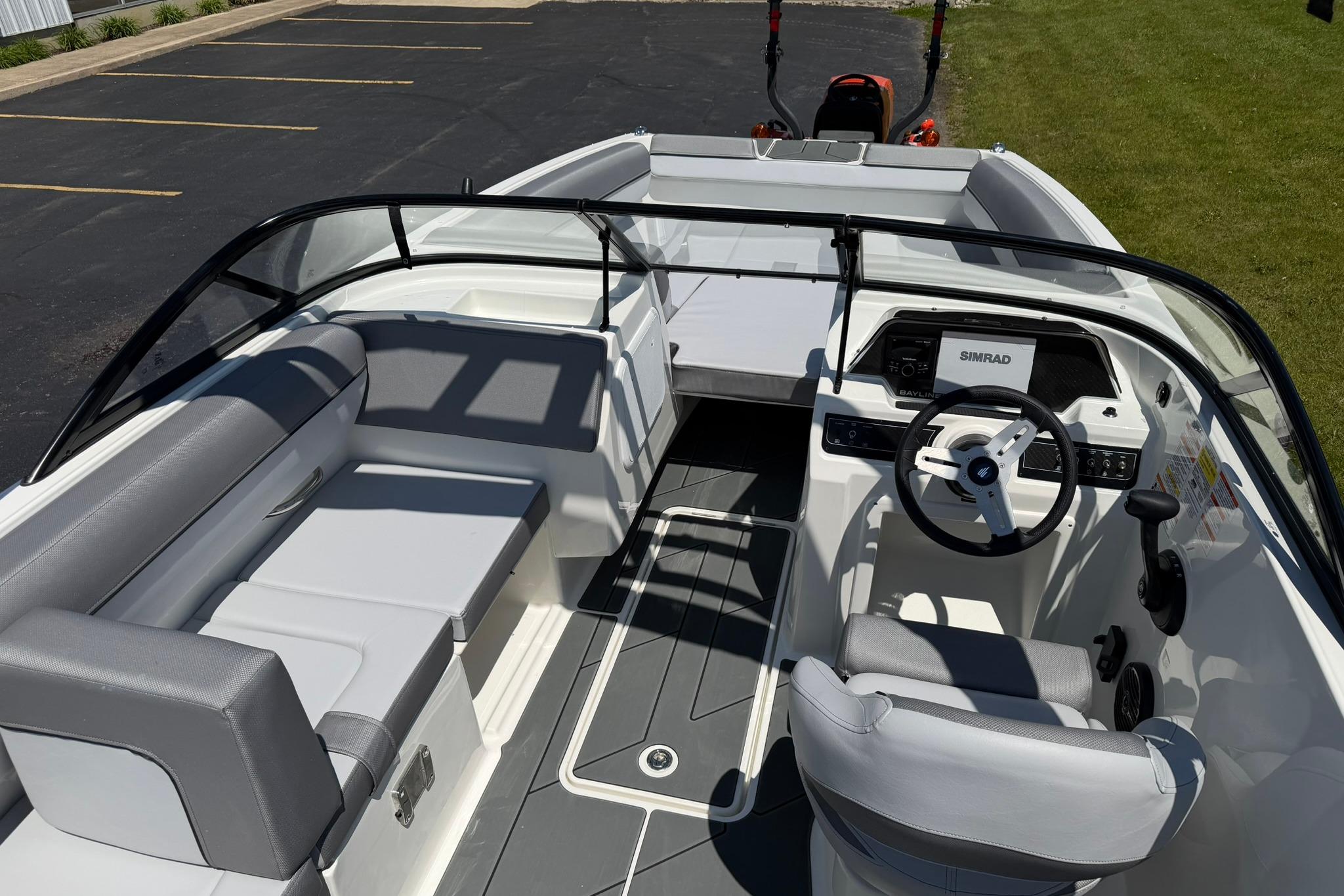 2026 Bayliner D20 boat interior with modern seating and steering console.