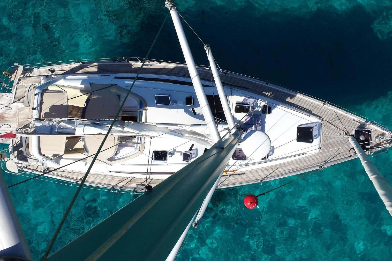 Aerial view of 2015 Wauquiez PS47 sailboat on clear turquoise water.