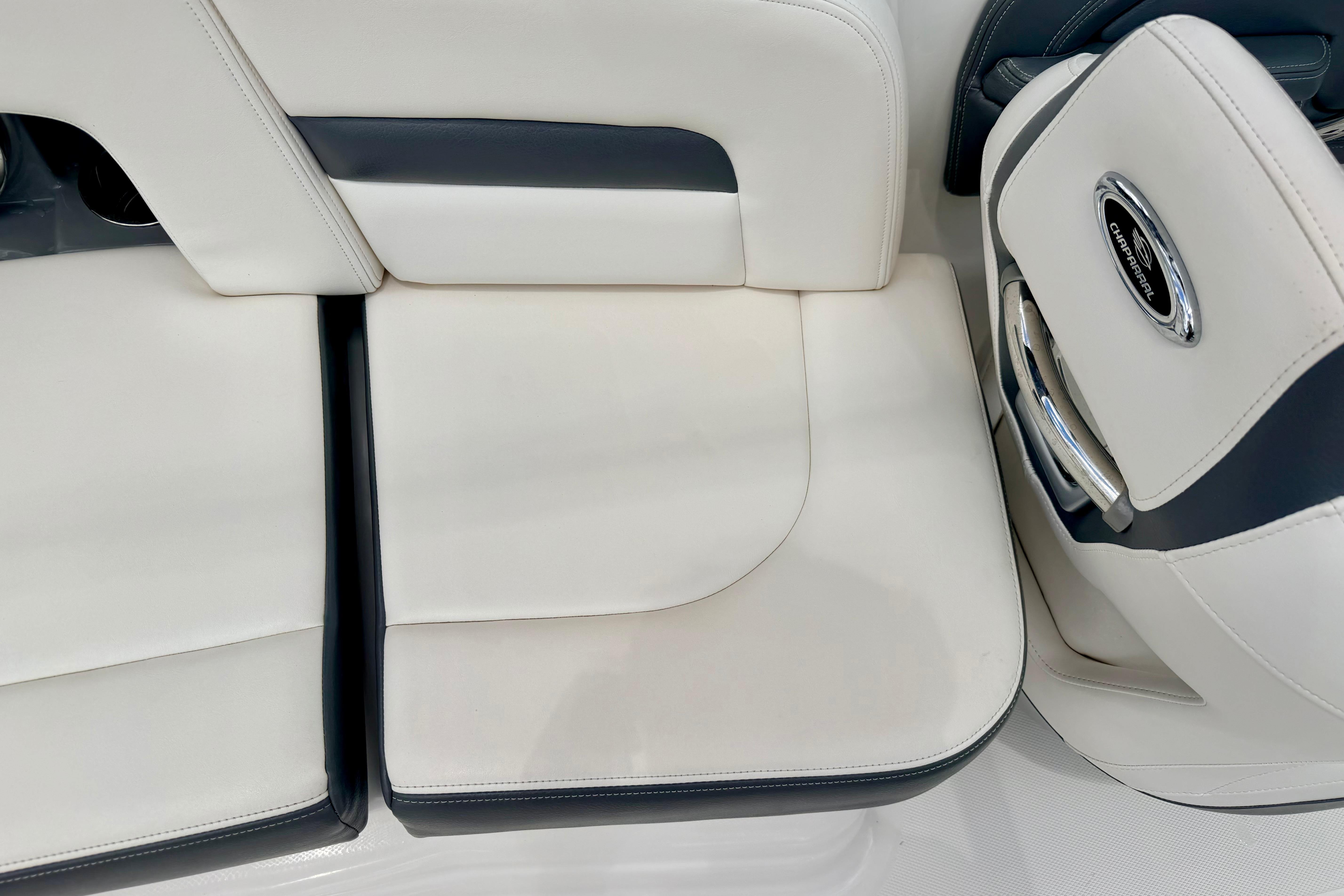 2015 Chaparral Sunesta 264 boat interior seating, featuring white and black upholstery.
