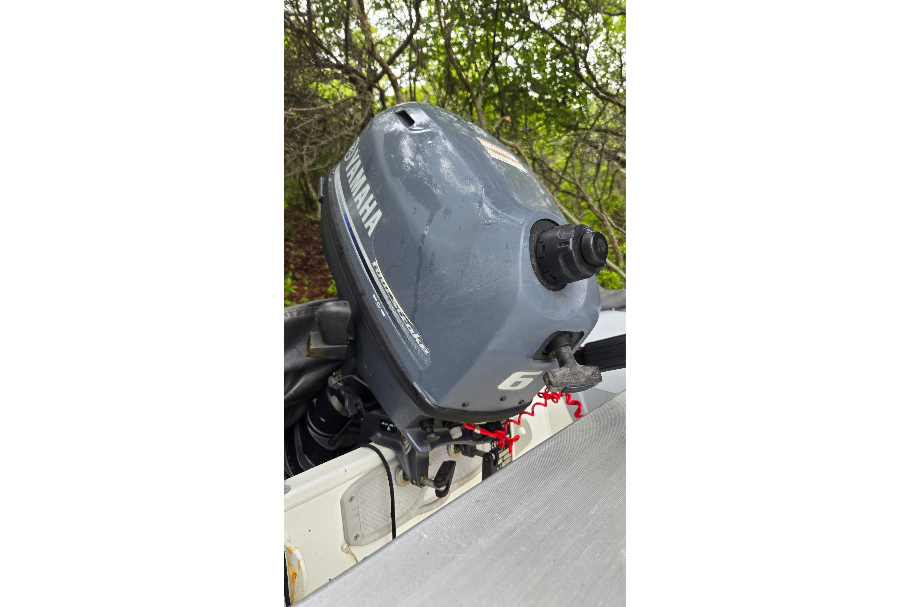 Yamaha outboard motor on a 1987 Marine Trader 36 boat, surrounded by greenery.