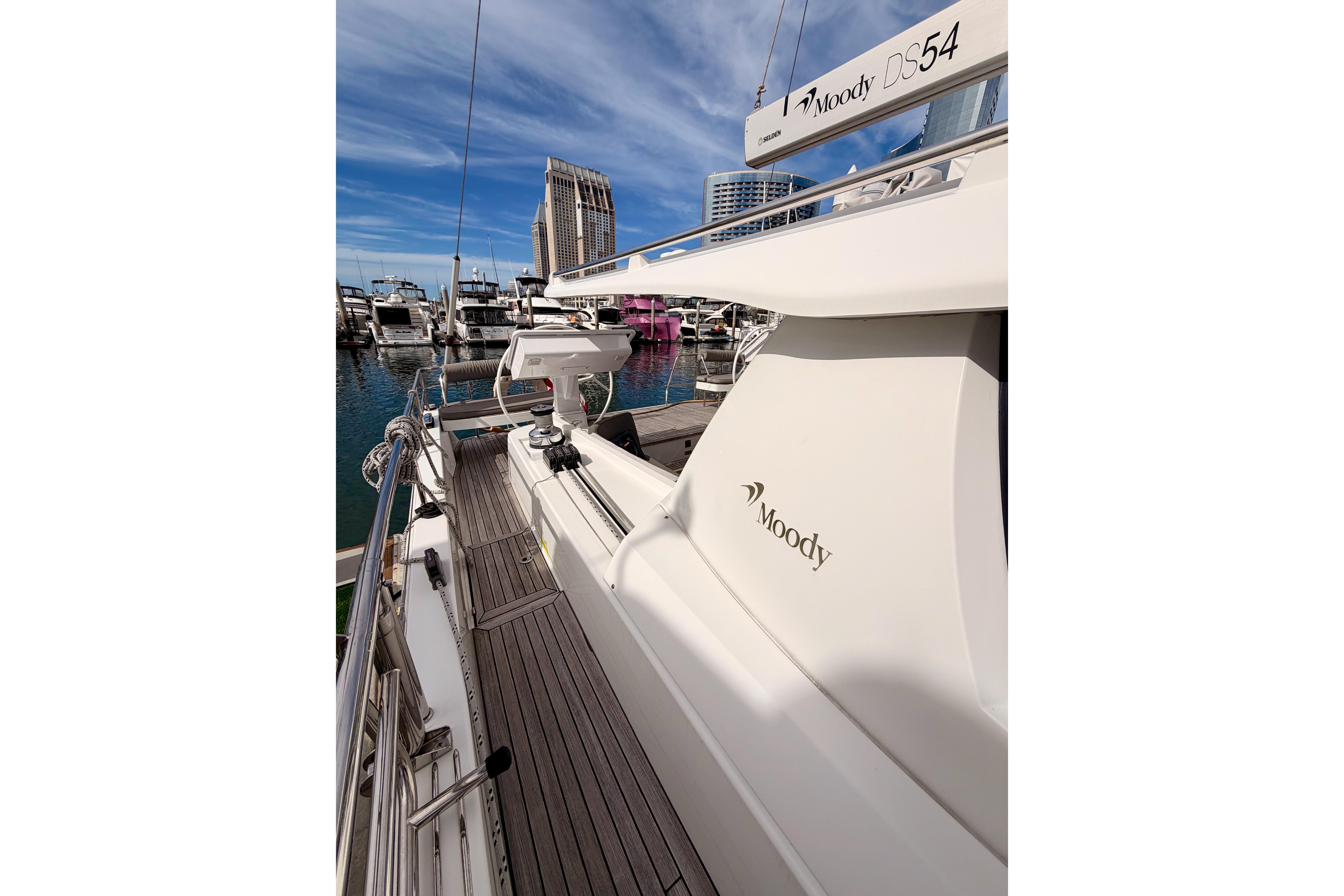 2016 Moody Decksaloon 54 yacht docked at marina, showcasing sleek design and luxury features.