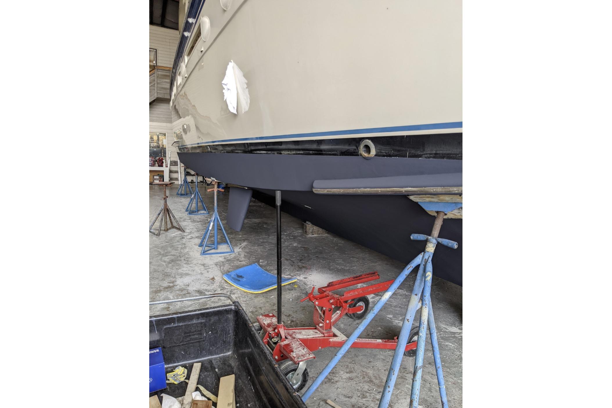 1984 Hatteras 53 Extended Deckhouse Motor Yacht in dry dock, supported by stands.