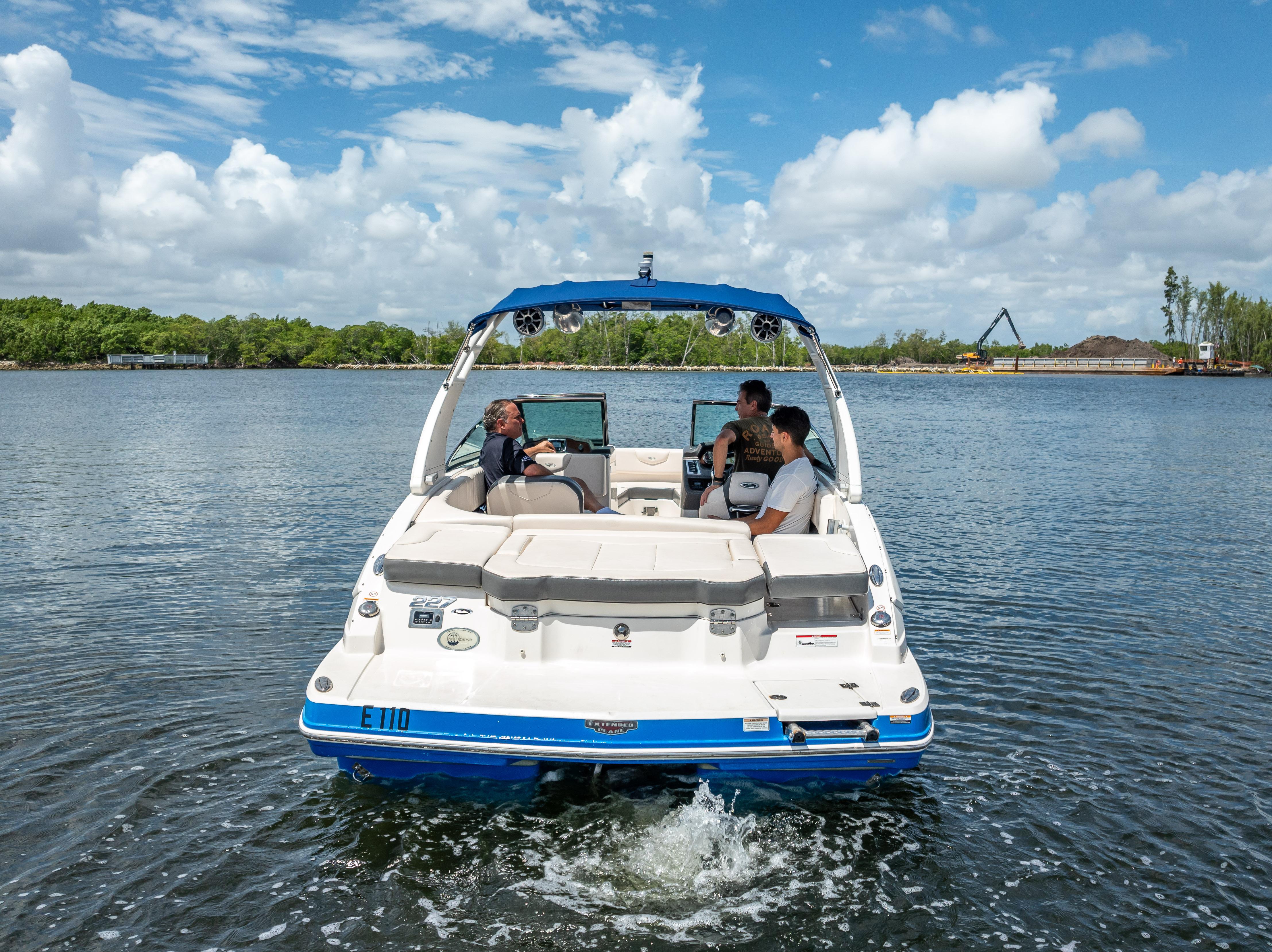 2017 Chaparral 227 SSX boat cruising on a sunny day with passengers onboard.