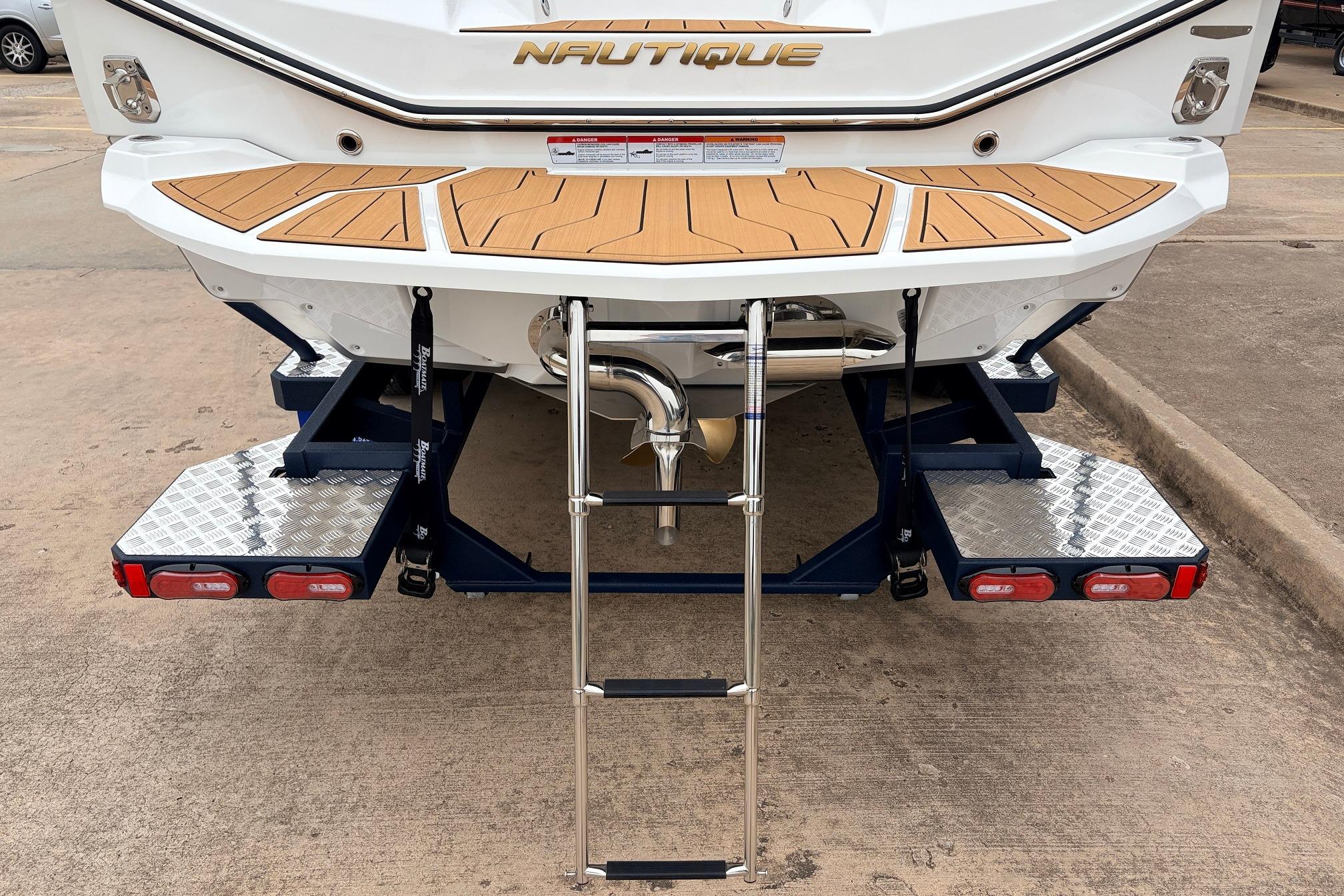 2026 Nautique Super Air Nautique G25 boat rear view with swim platform and ladder.