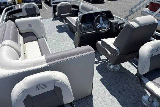 2026 Sun Tracker Fishin' Barge 20 DLX interior with plush seating and modern steering console.