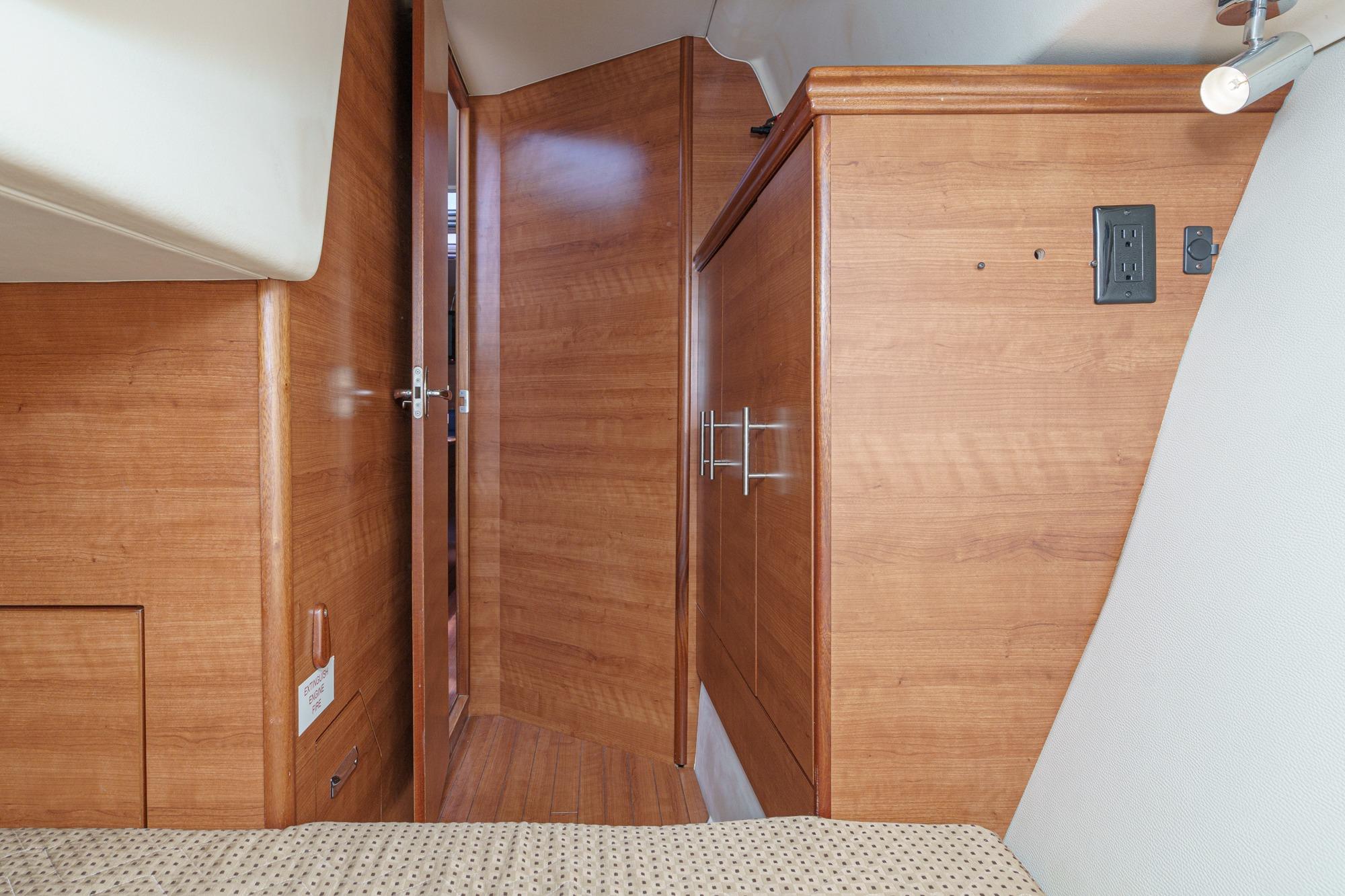 Interior of a 2015 Hunter 33 sailboat featuring wooden cabinetry and modern design elements.
