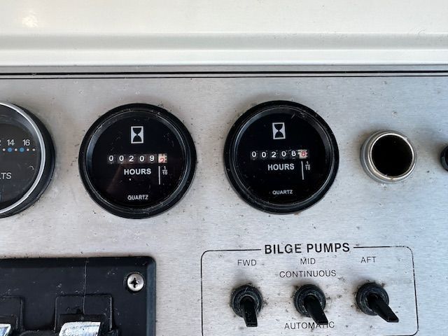 Carver 3807 yacht dashboard with hour meters and bilge pump controls.