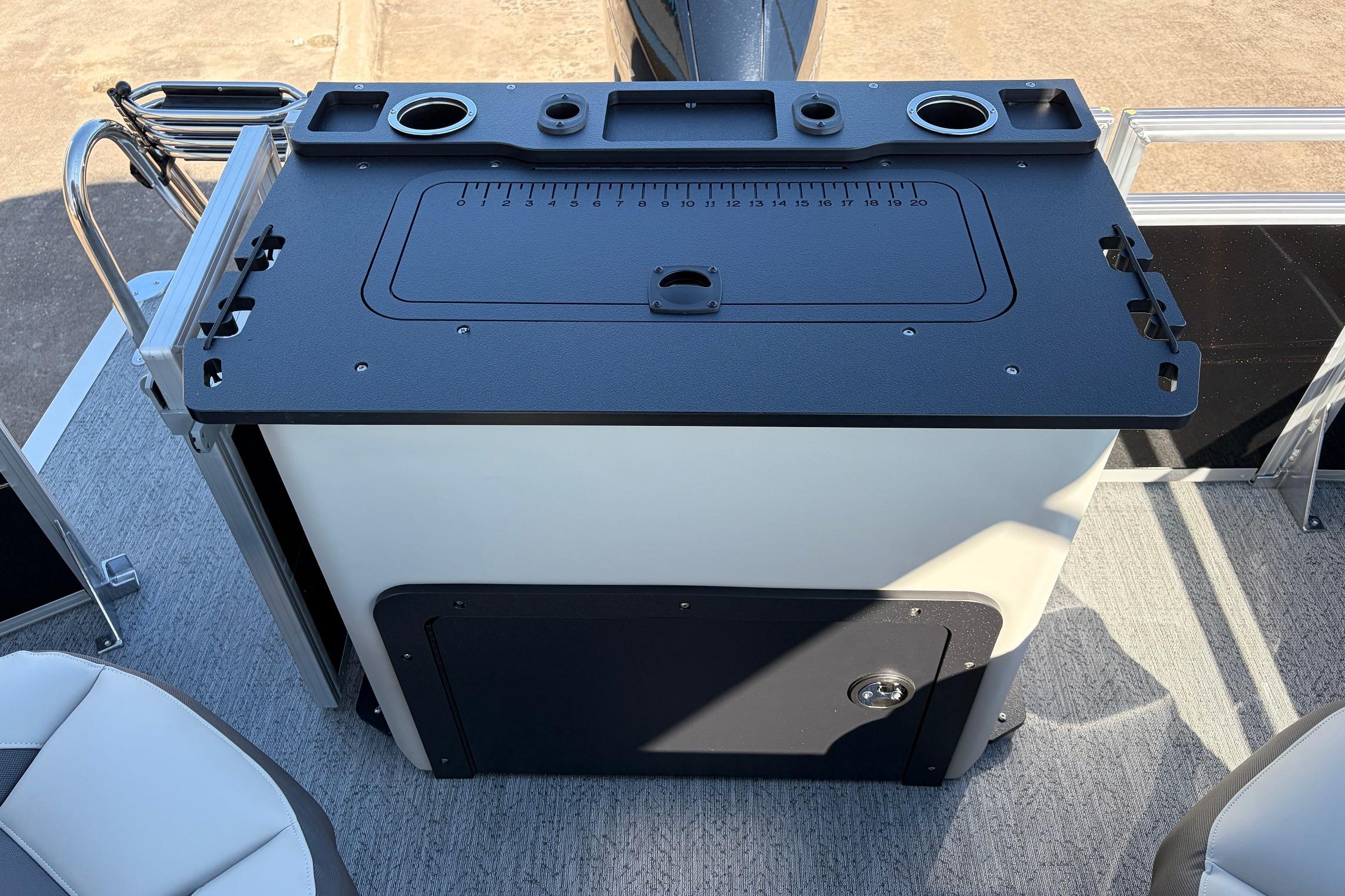 2026 Sun Tracker Fishin' Barge 22 XP3 fishing station with rod holders and storage.