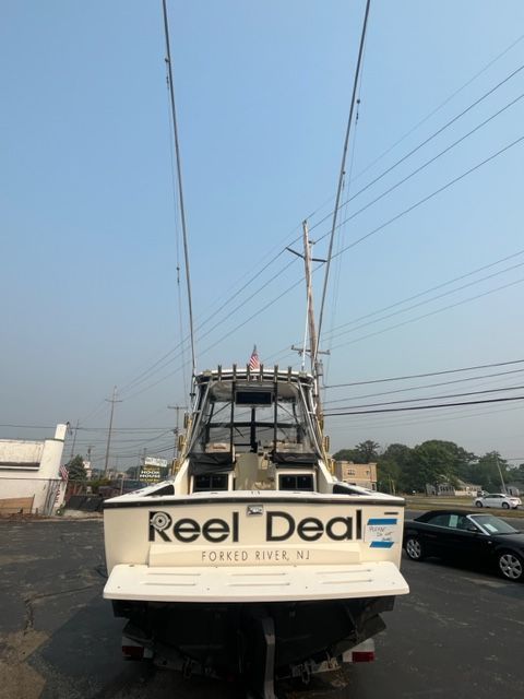 Rear view of a 2002 Carolina Classic 25 boat in the harbor.