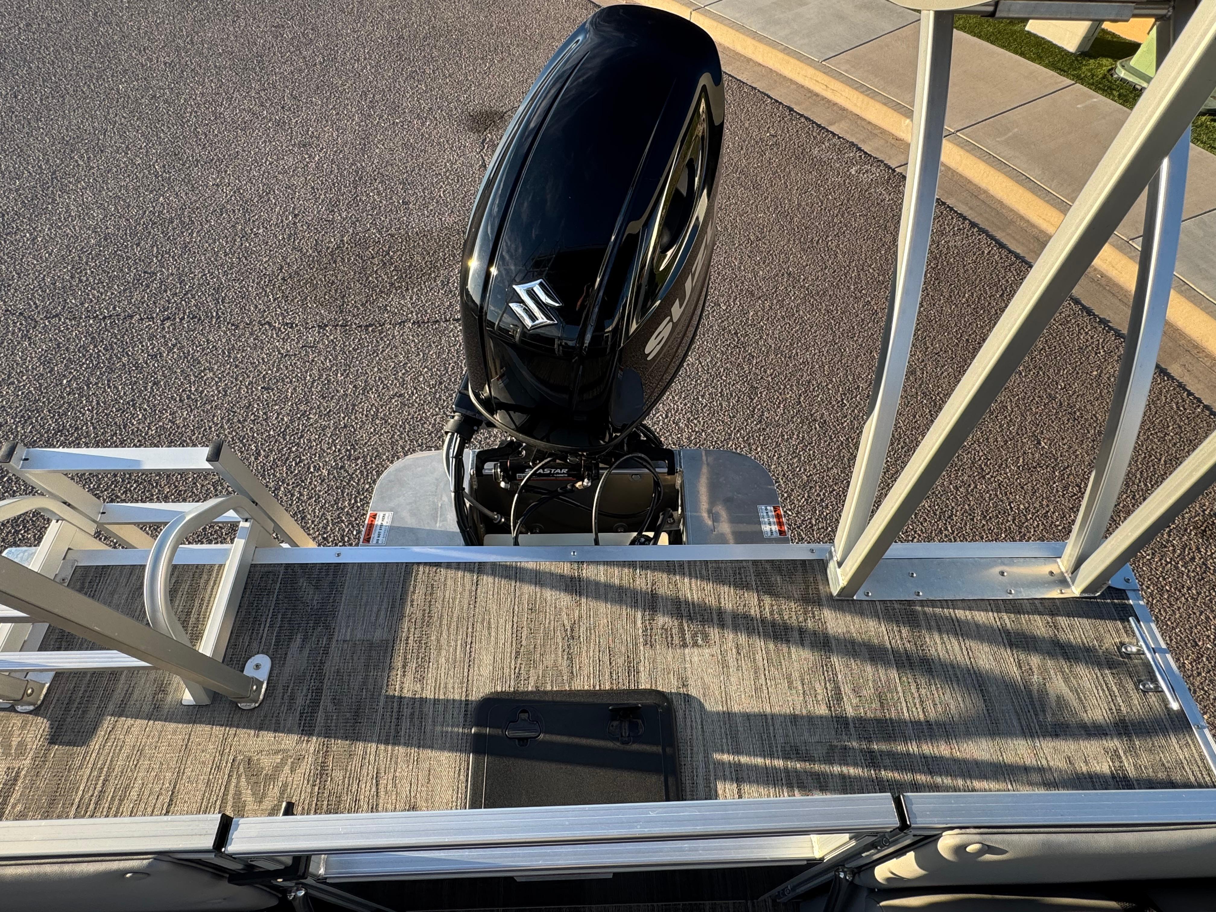 2024 Landau Island Breeze 252 pontoon boat with Suzuki outboard motor, viewed from above.