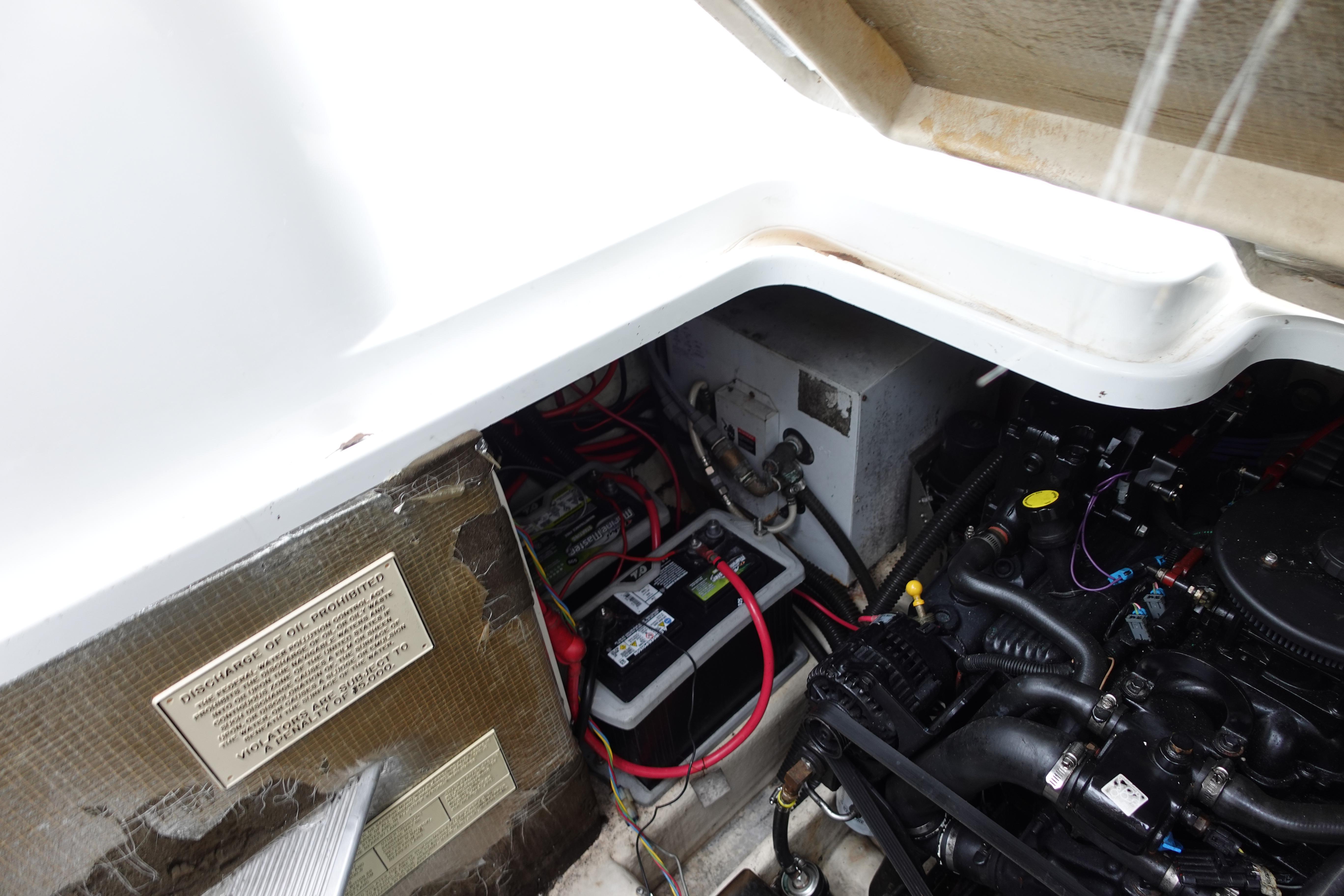 Engine compartment of a 2020 Boston Whaler 420 Outrage, showing battery and wiring.