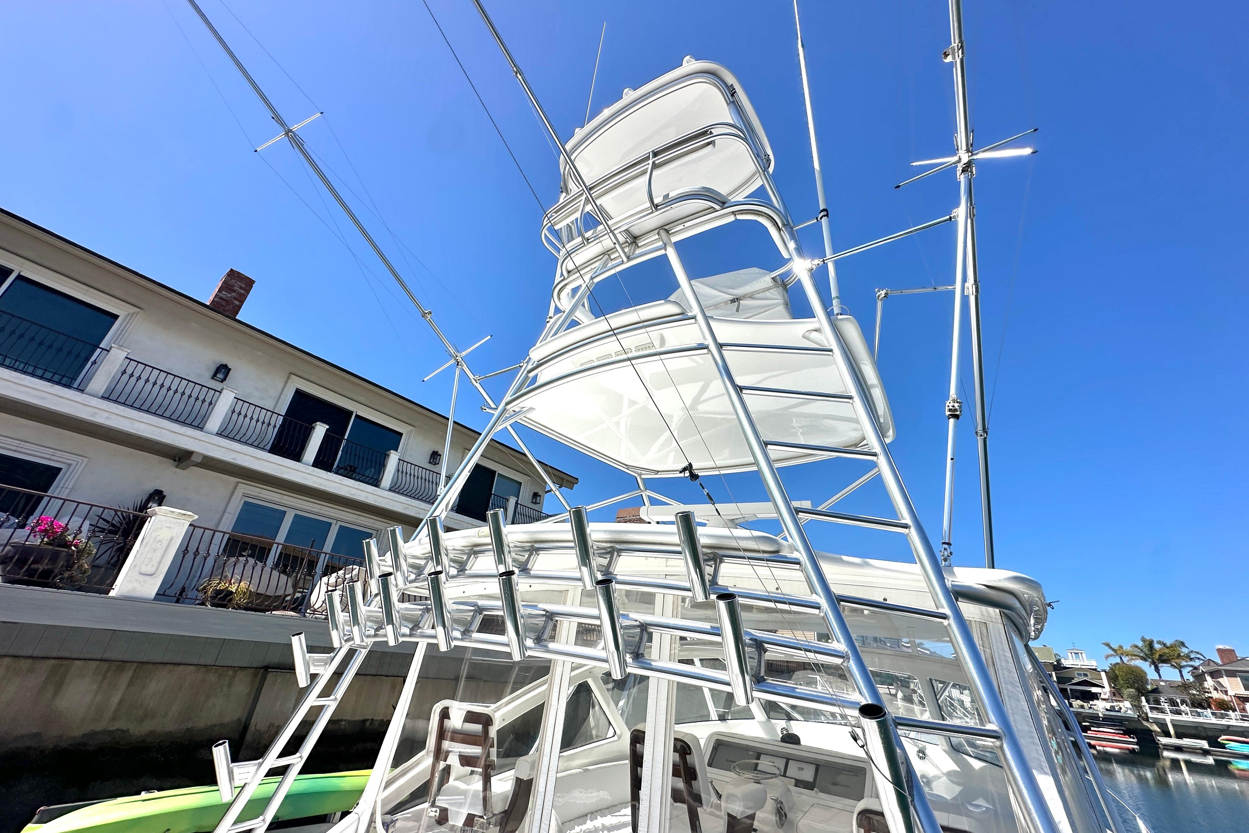 2012 Viking 42 Open yacht with tower against clear blue sky.