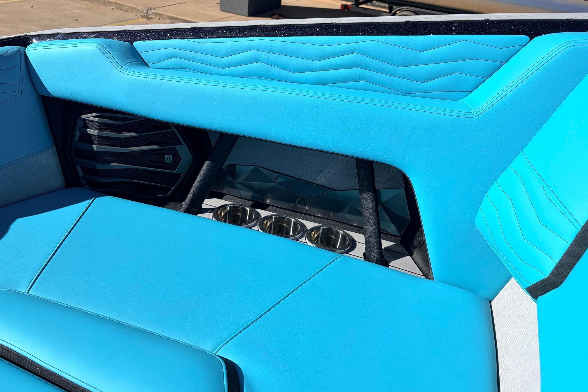 Interior of 2026 Nautique Super Air Nautique G23 with blue seating and cup holders.