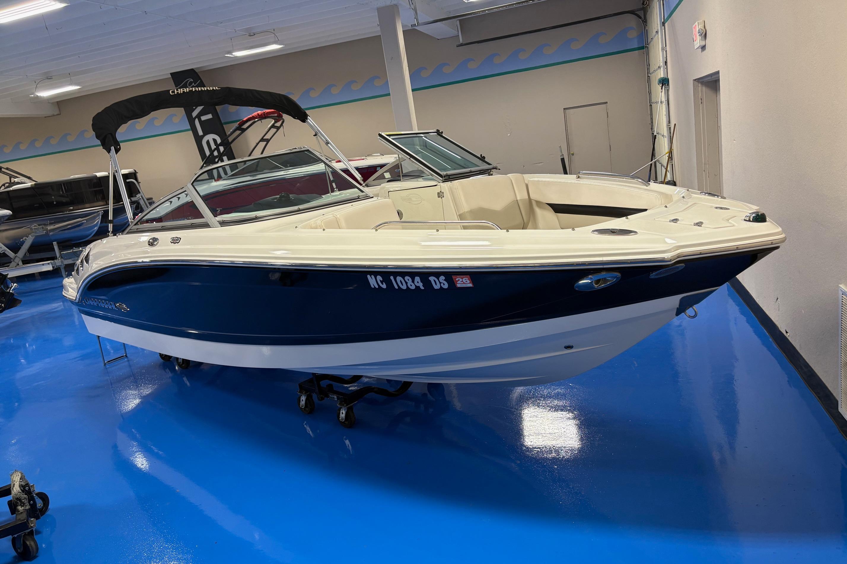 2011 Chaparral 216 SSi boat displayed indoors on a shiny blue floor.
