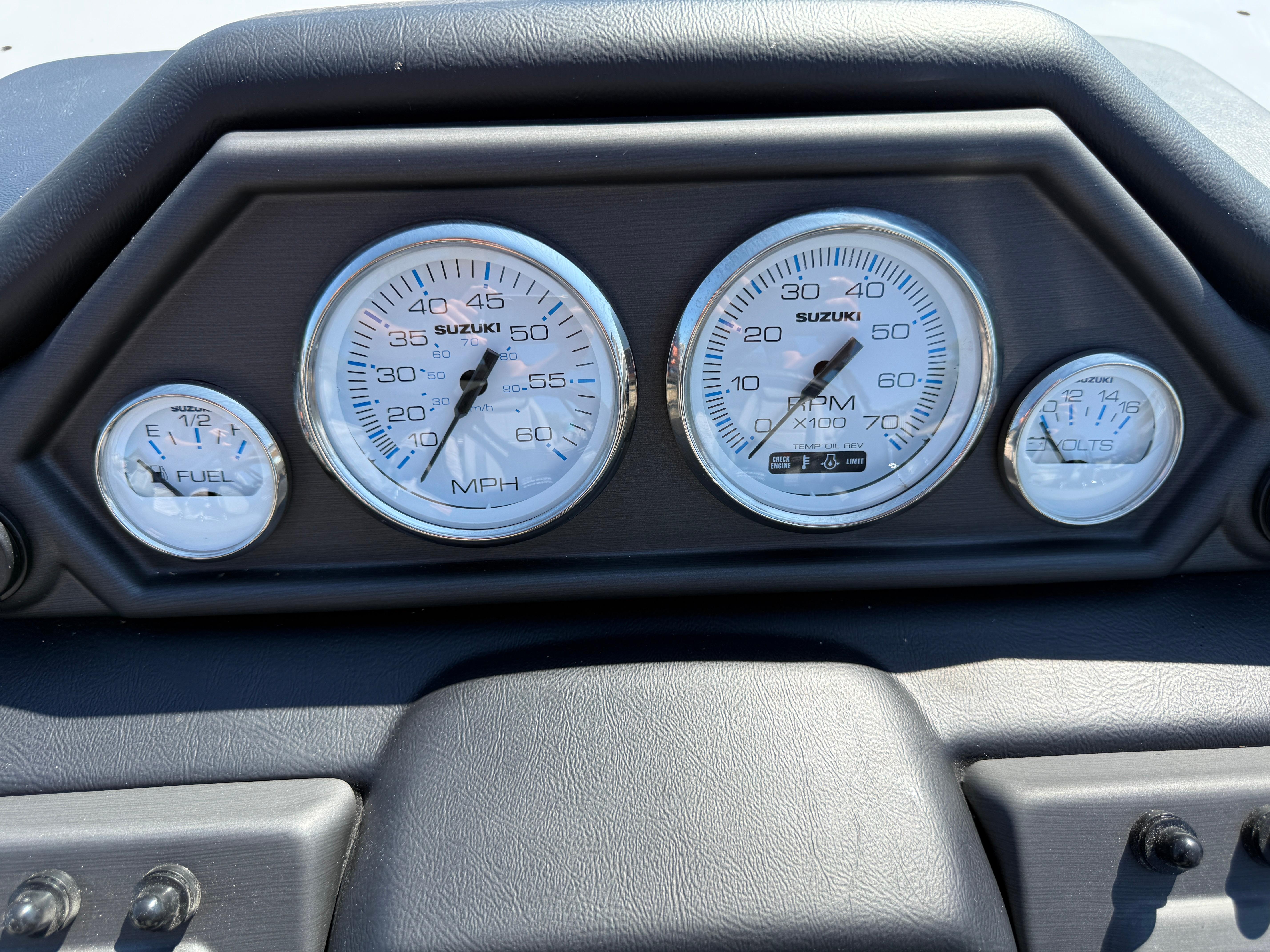 Dashboard of 2026 Bentley Pontoons Legacy 223 Navigator with Suzuki gauges.