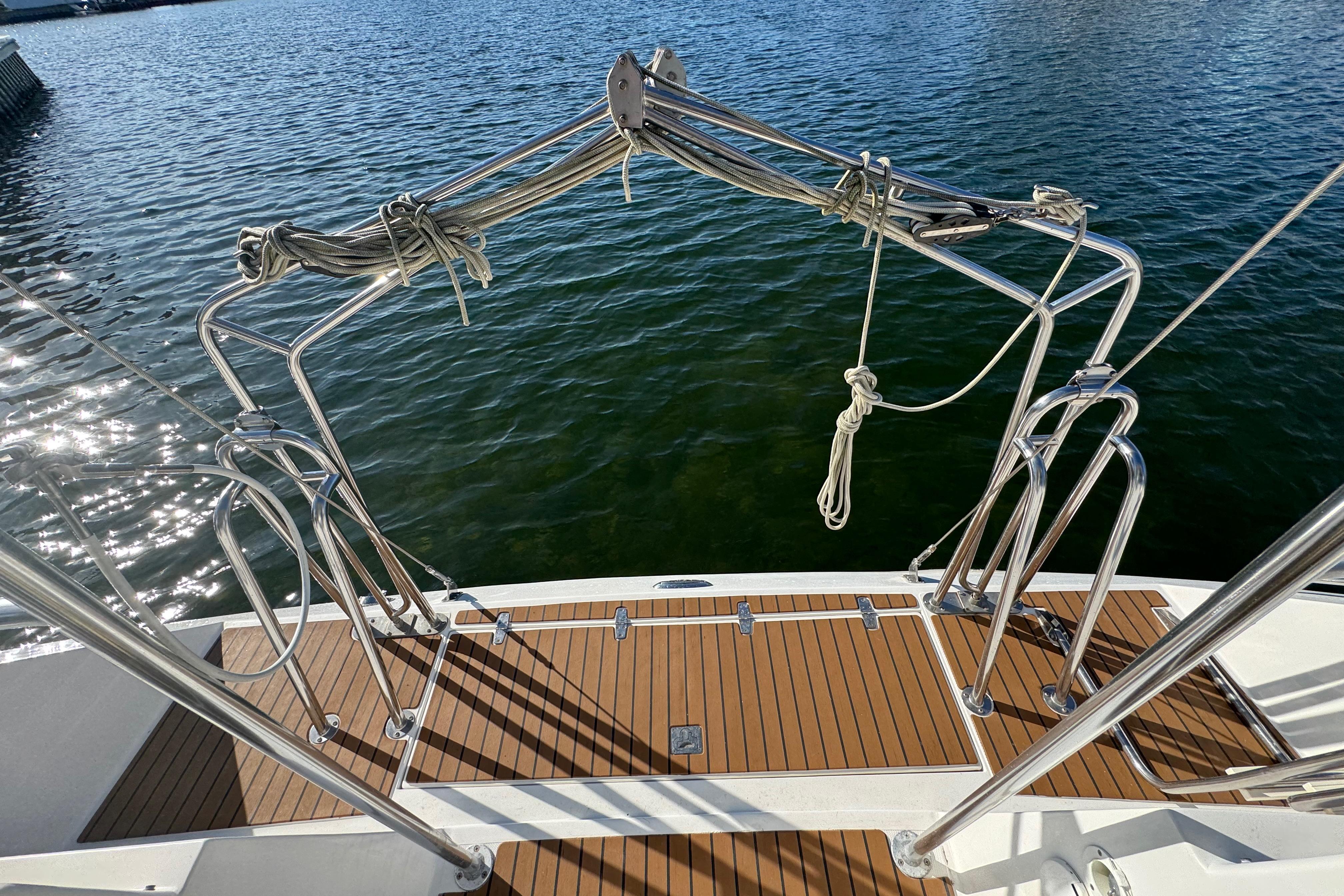 Stern view of 2006 Shannon Shoalsailer with stainless steel railings and teak deck.