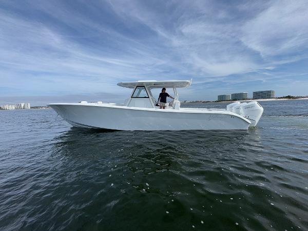 2025 Yellowfin 39 Offshore boat cruising on open water under a cloudy sky.