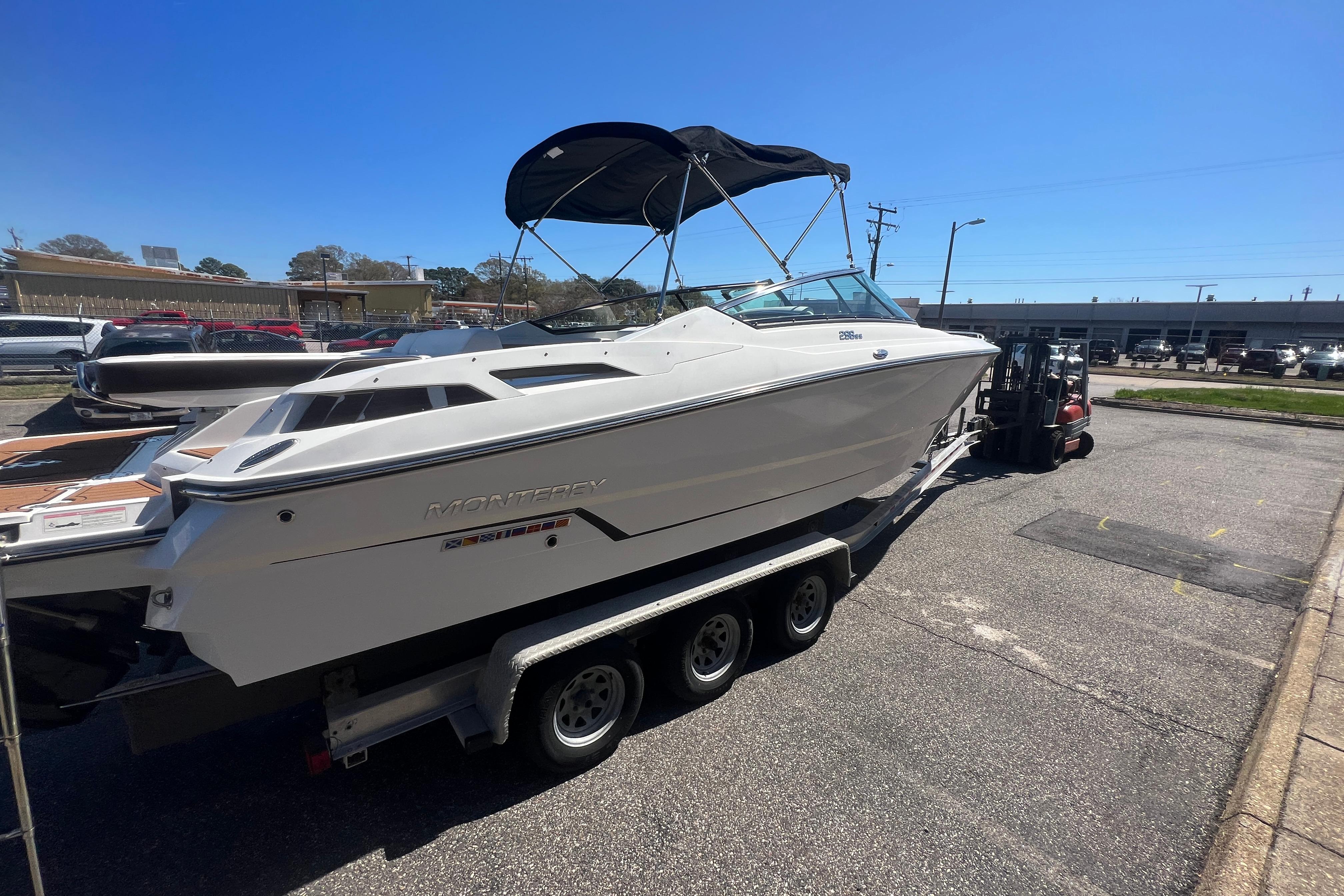 2017 Monterey 298SS Super Sport boat on trailer in parking lot.