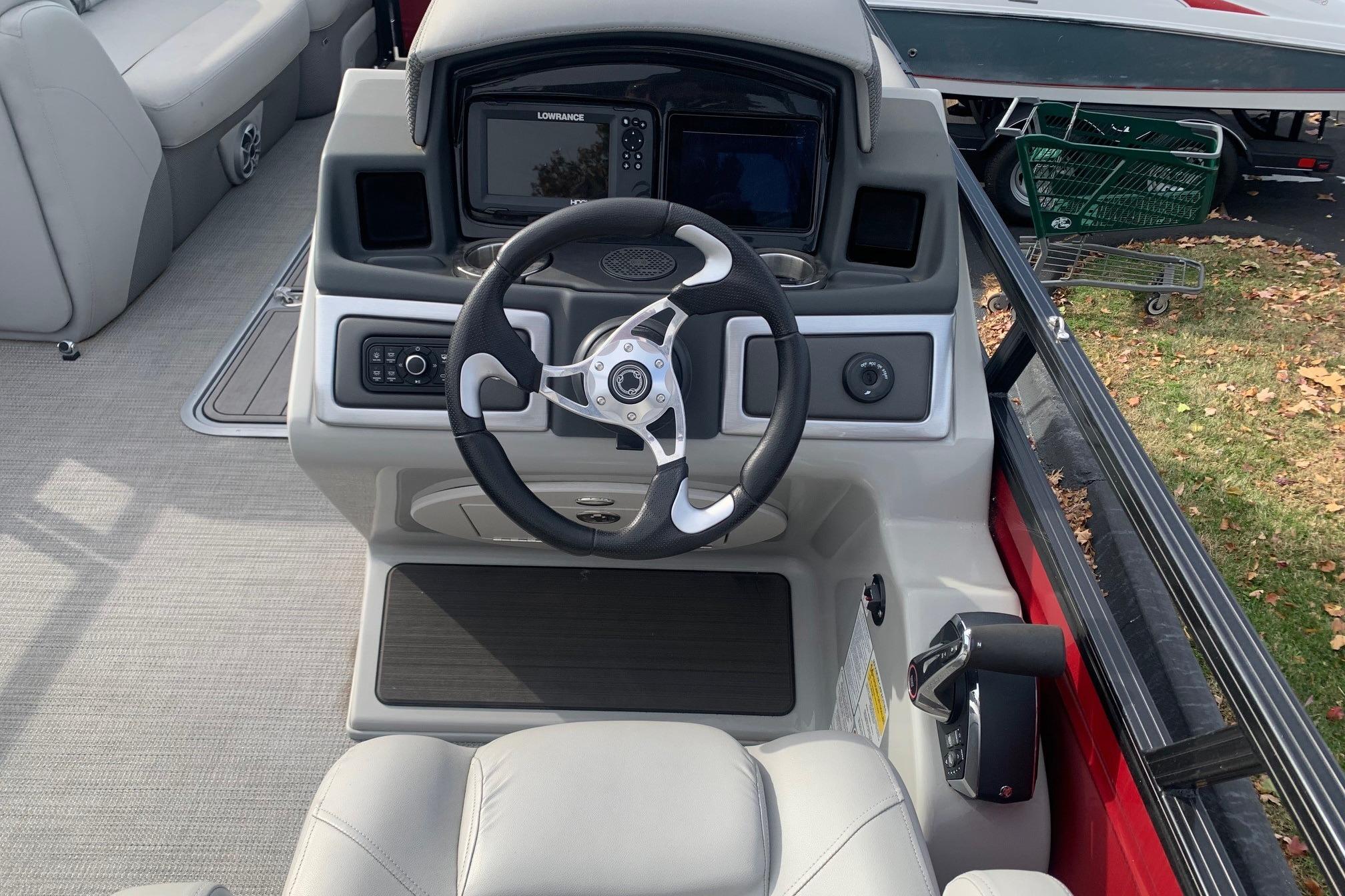 2024 Regency 250DL3 boat helm with steering wheel and navigation system.