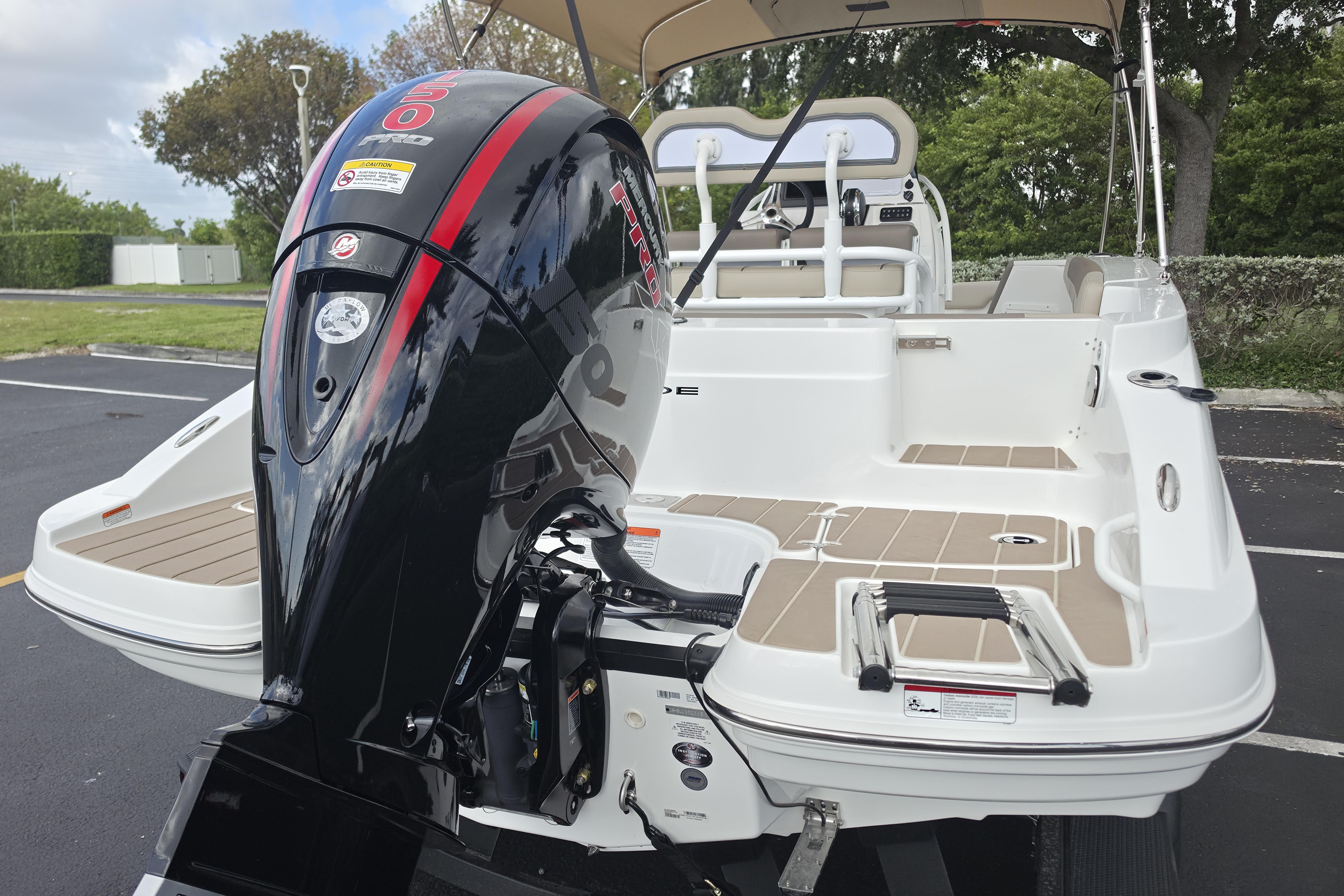 2026 Tahoe 2150 CC boat with powerful outboard motor, parked outdoors.