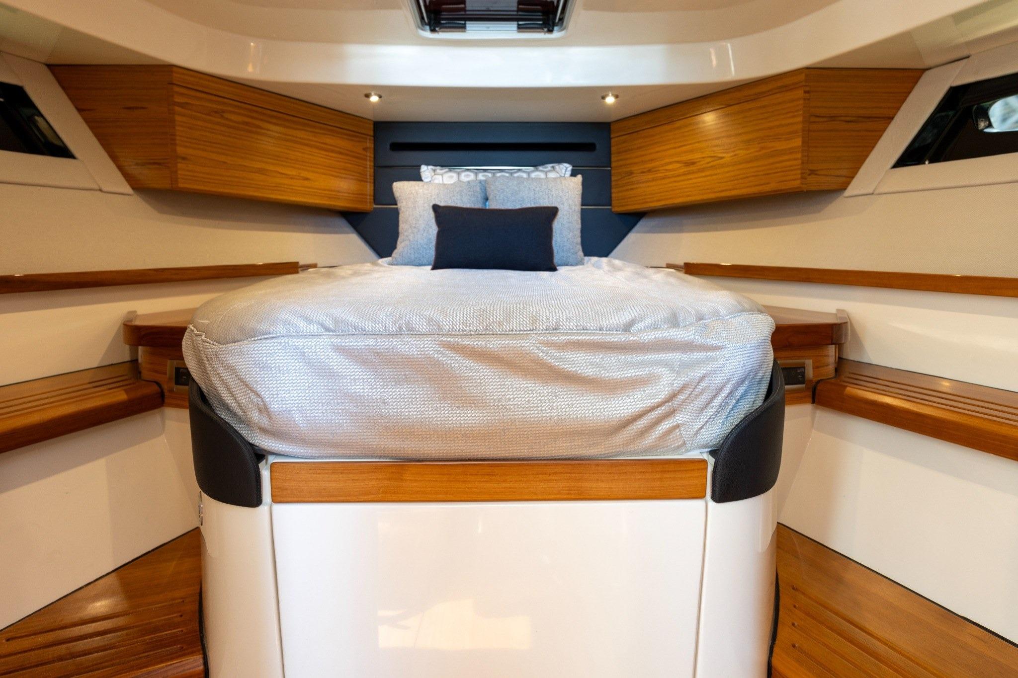 Luxurious cabin interior of 2023 Boston Whaler 405 Conquest with elegant wood accents.