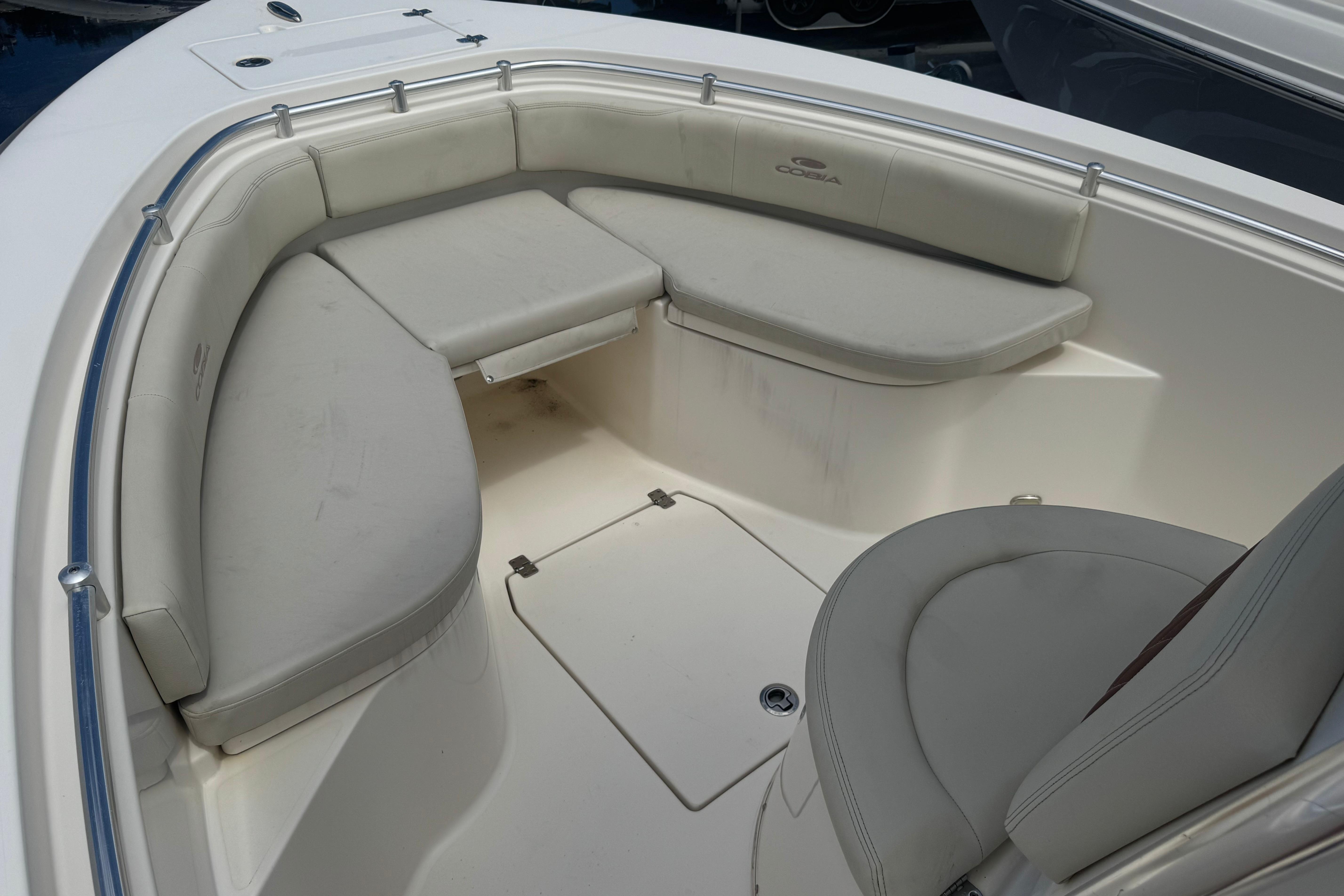 2022 Cobia 237 Center Console boat with cushioned seating area.