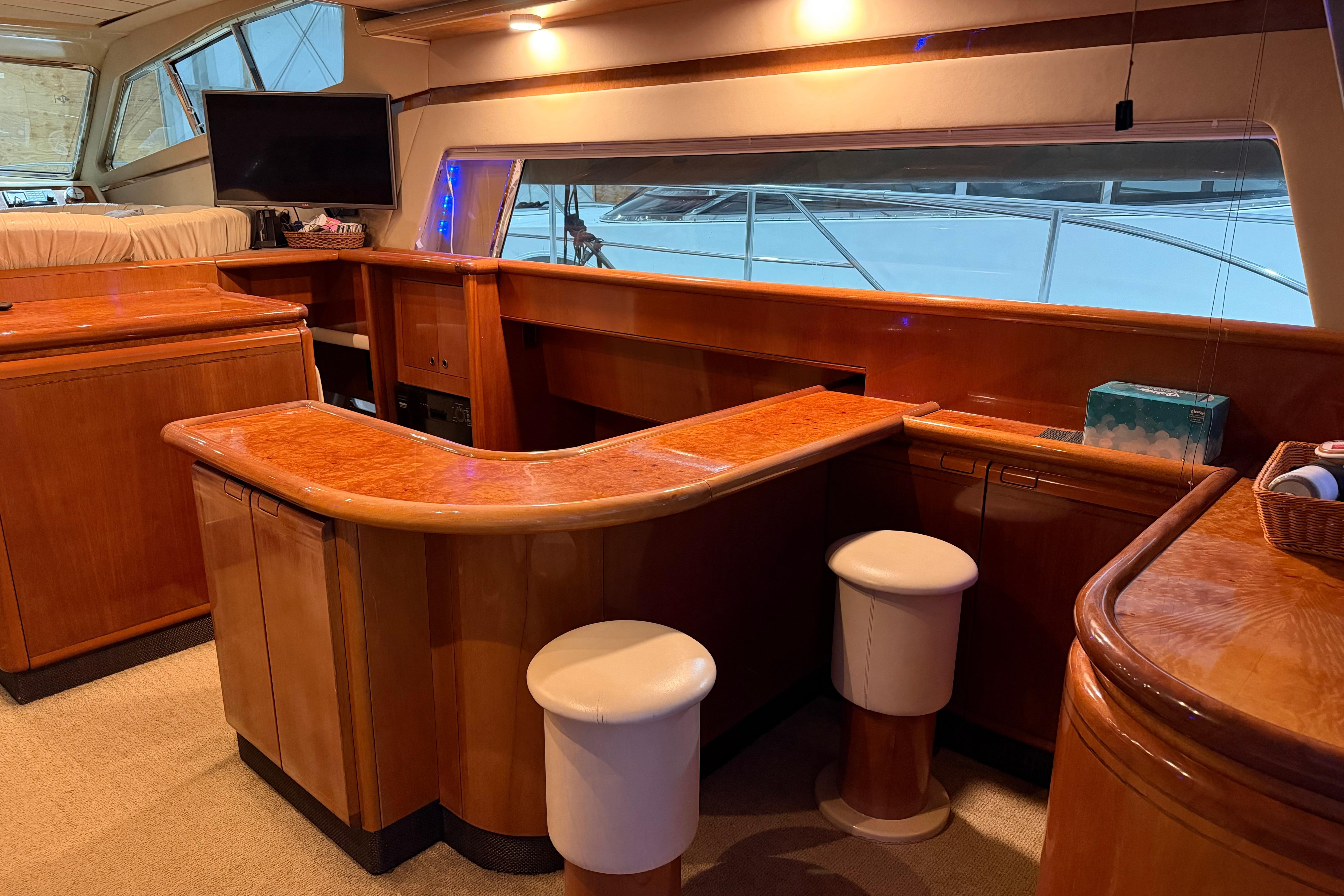 Luxurious interior of 1994 Ferretti Yachts 185 Fly with elegant wood finishes and seating.