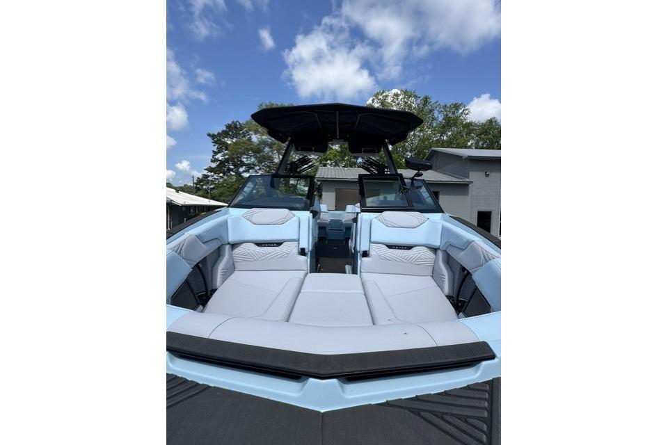 2026 MasterCraft XStar 25 boat with sleek interior design under a clear blue sky.