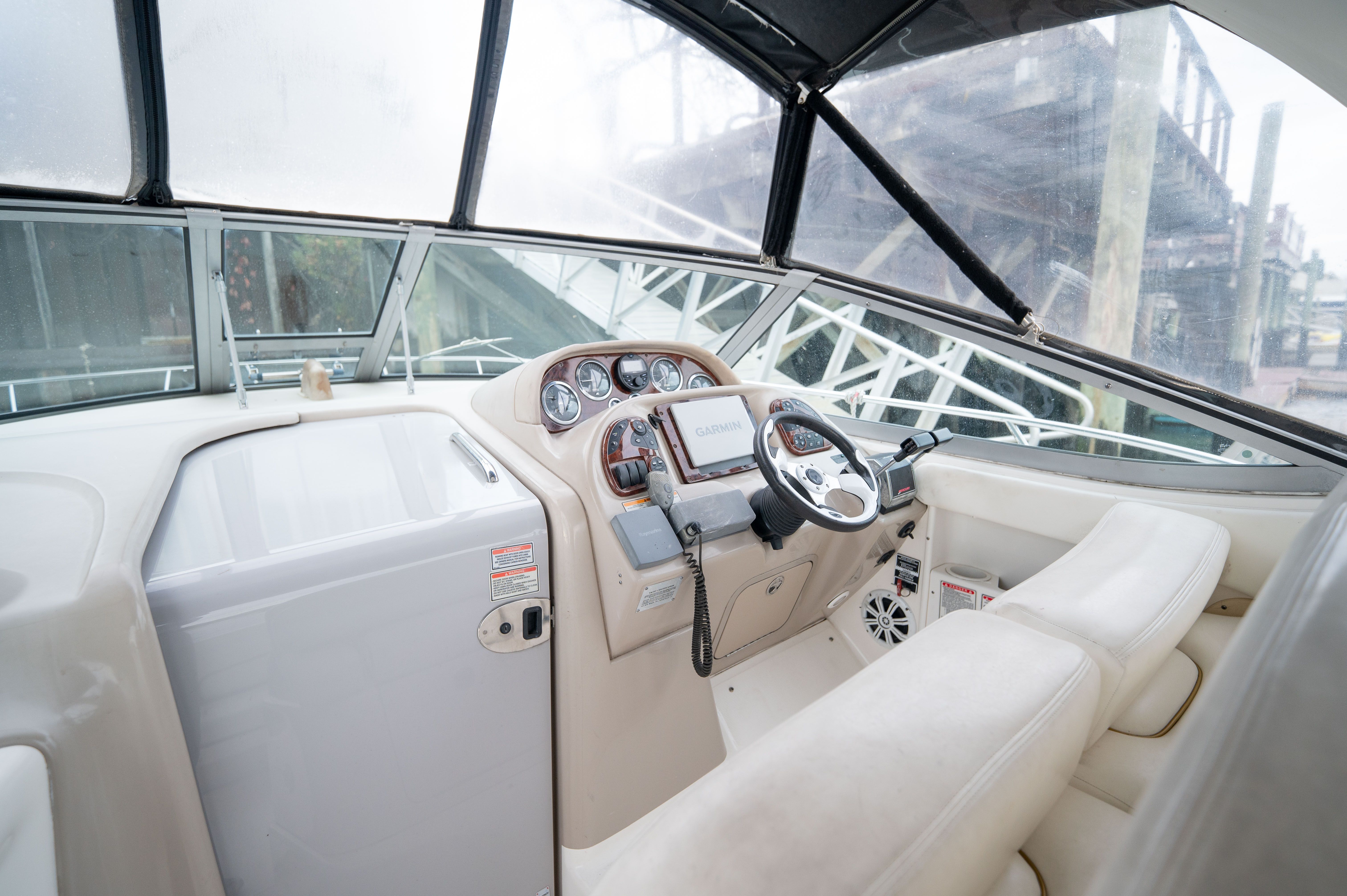 Interior of 2003 Sea Ray 300 Sundancer with helm console.