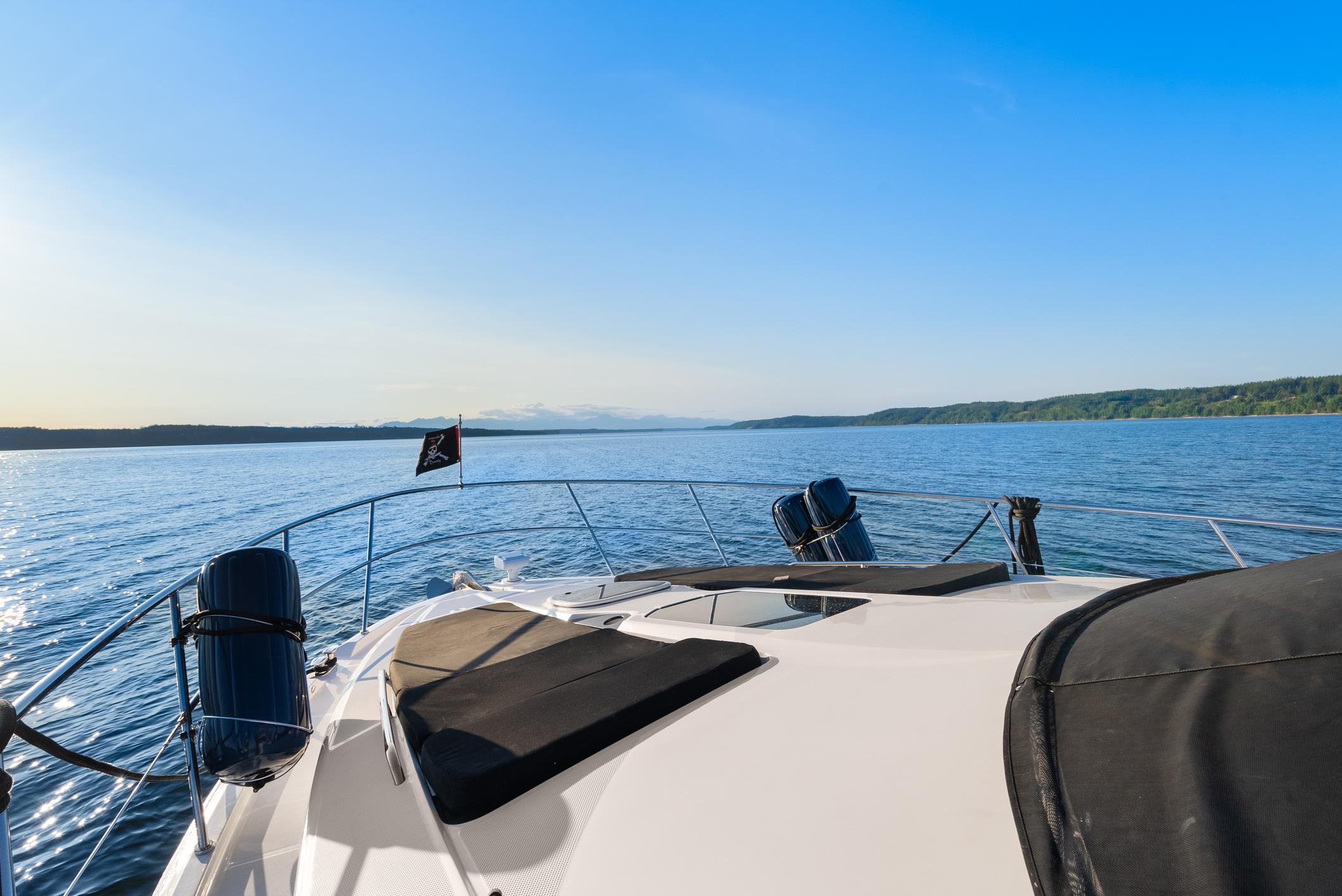 2012 Meridian 541 Sedan yacht cruising on a serene blue lake under a clear sky.