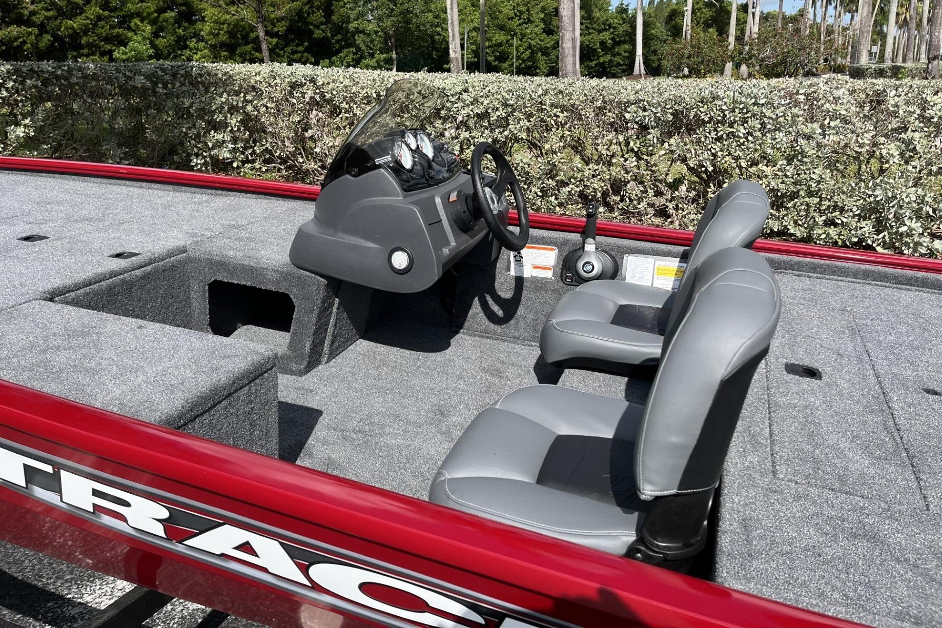 2026 Tracker Pro 170 boat interior with gray seats and steering console.