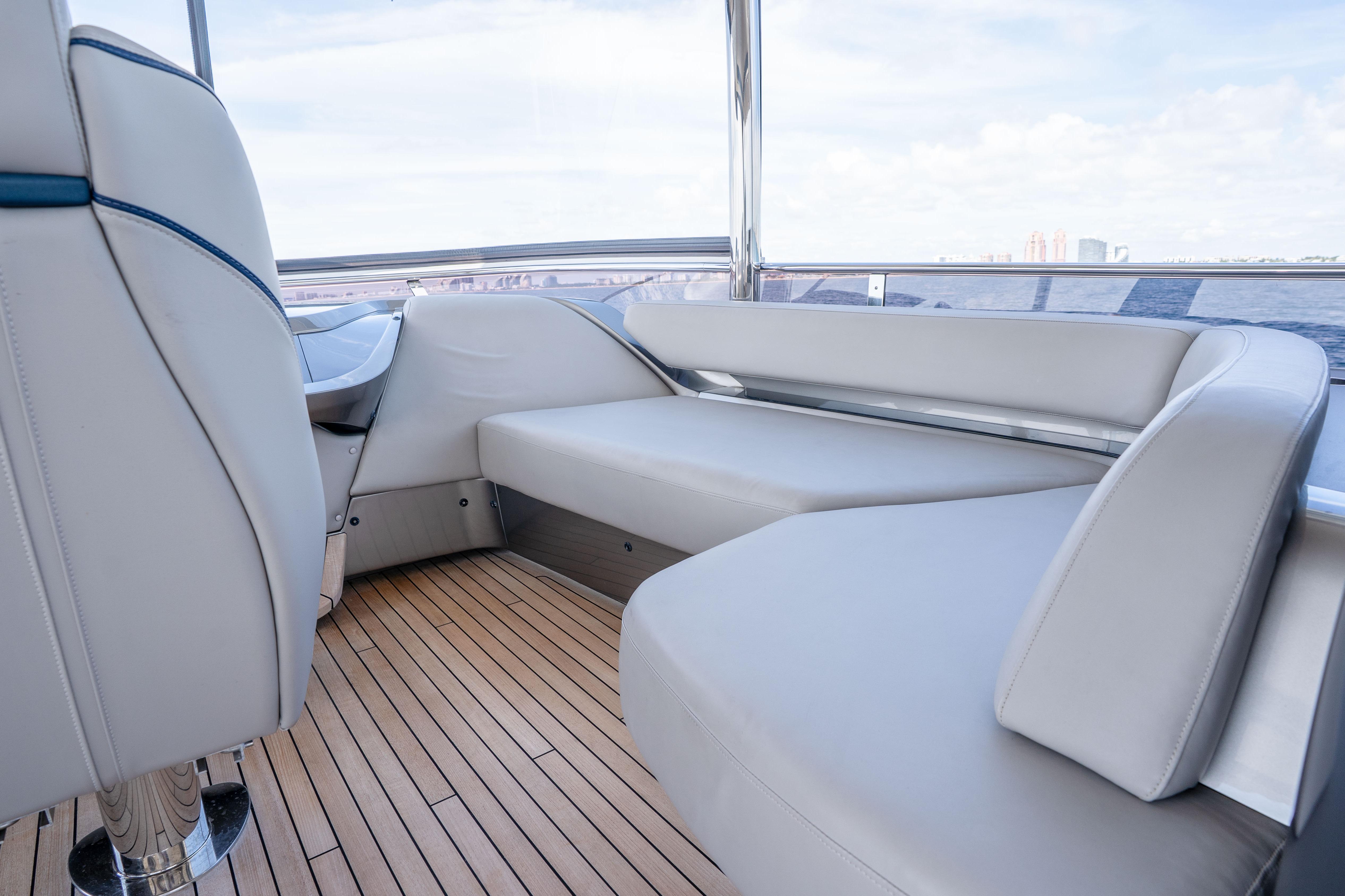 Luxurious interior of 2020 Princess Y85 yacht with sleek seating and wooden flooring.