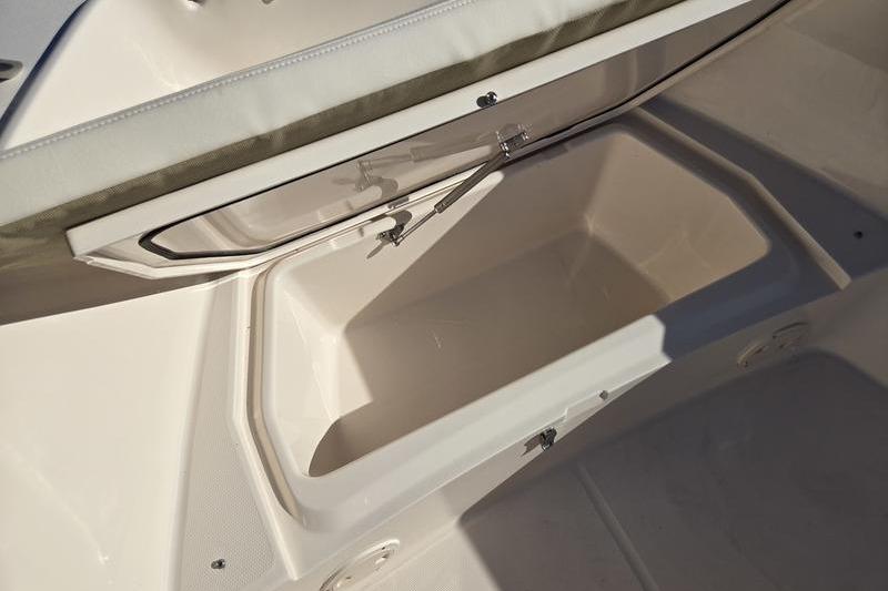 Storage compartment on 2026 Grady-White Fisherman 180 boat, open and empty.