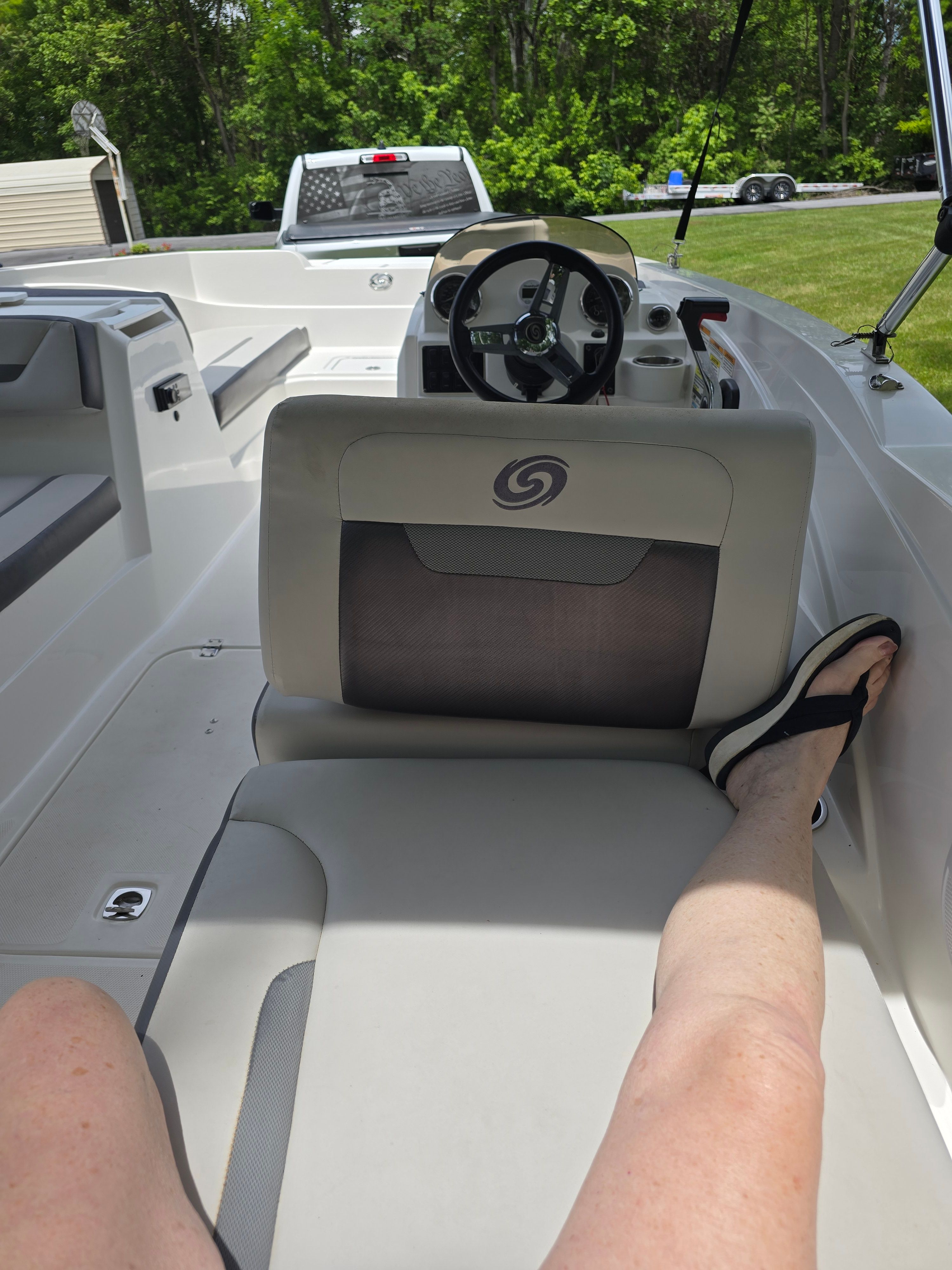 Interior of a 2021 Hurricane 205SS boat with a relaxed person.