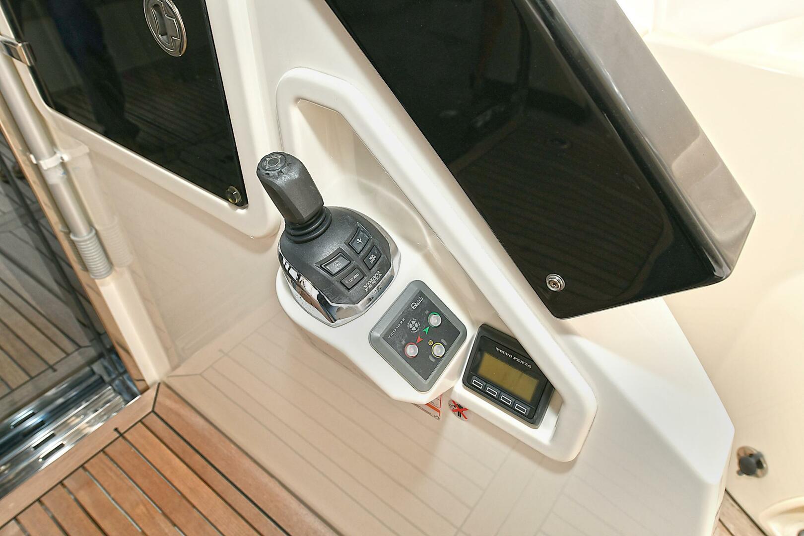 Control panel of 2022 Absolute 62 Fly yacht with joystick and digital display.
