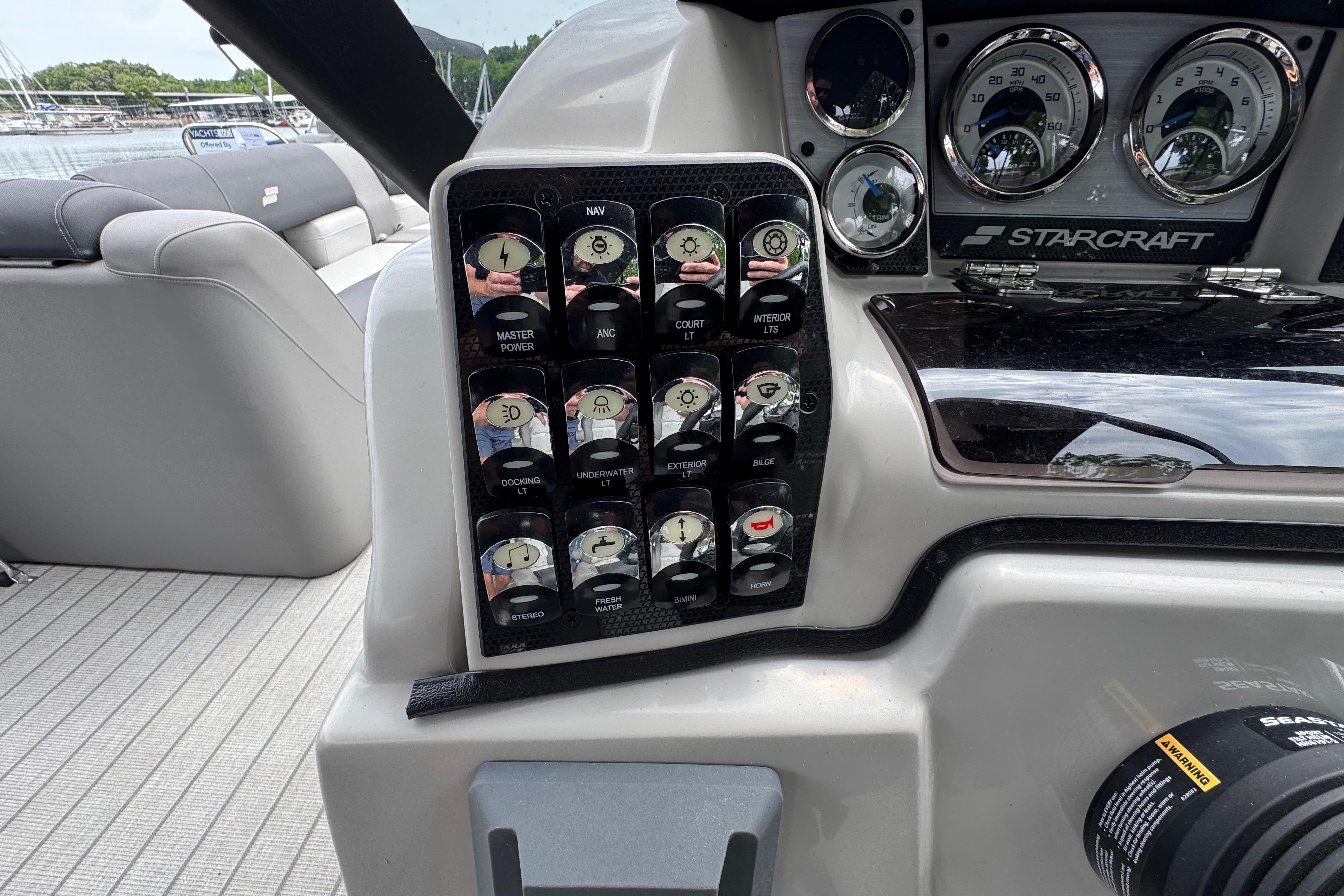 Control panel of 2023 Starcraft MX 25 DL DH boat with various switches and gauges.