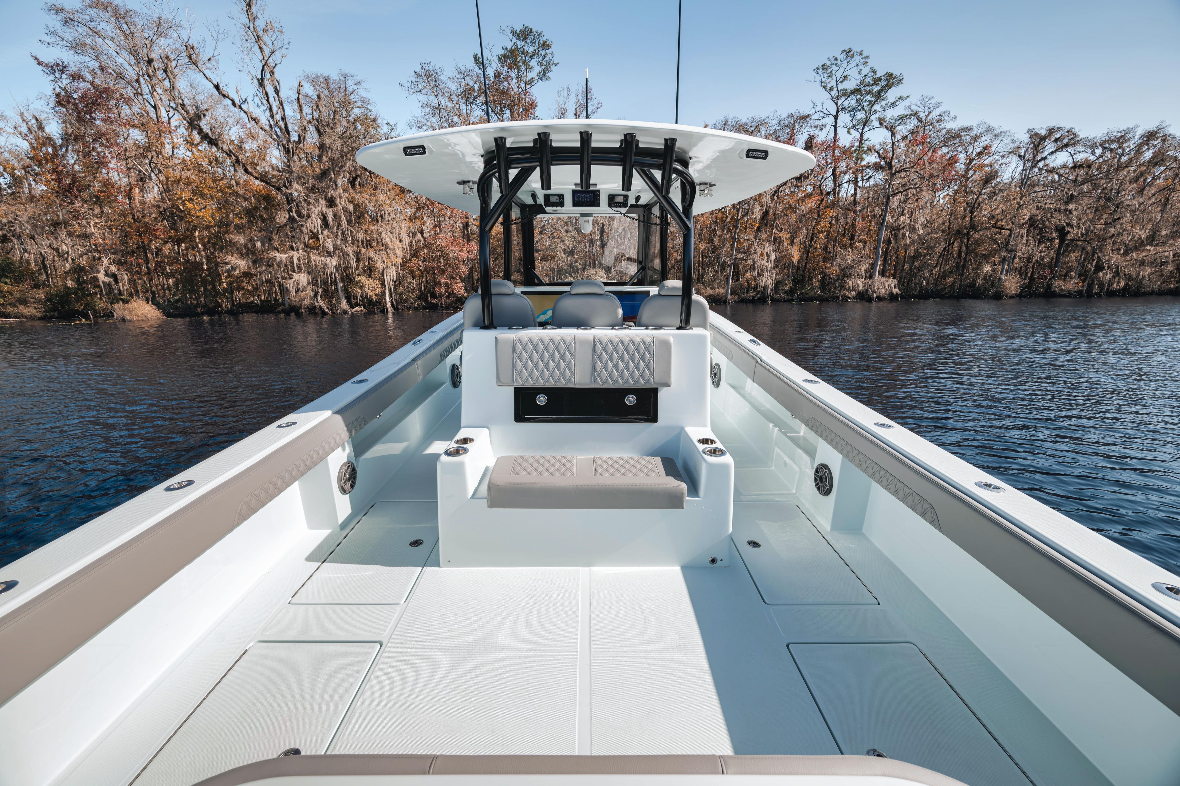 2026 Front Runner 37' Catamaran on serene lake with autumn trees in background.