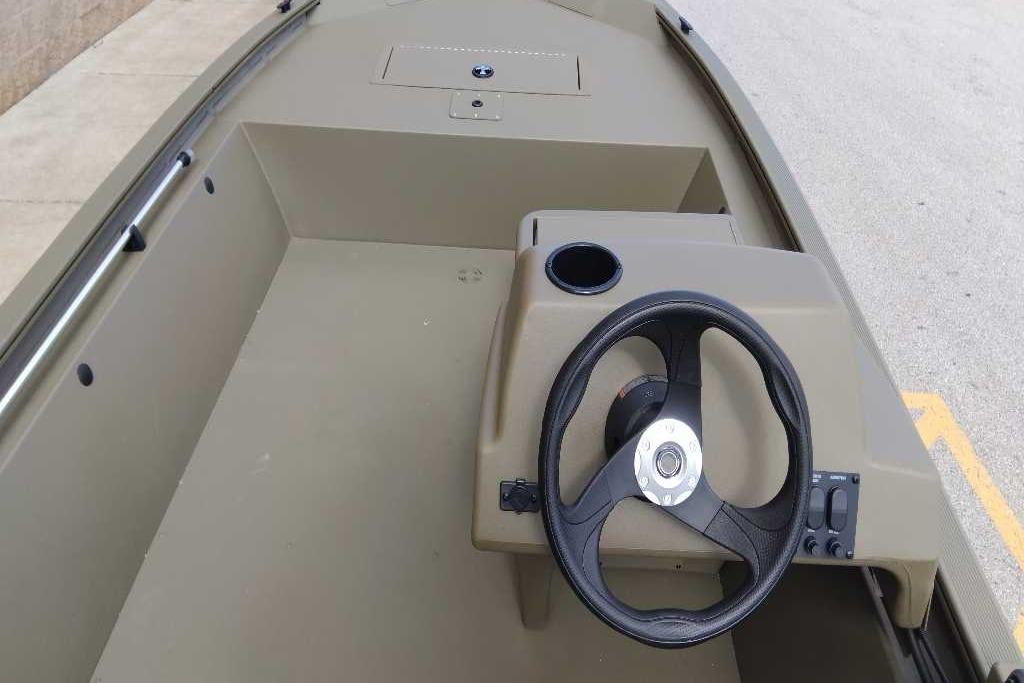 2026 Tracker Grizzly 1648 SC boat interior with steering wheel and console.