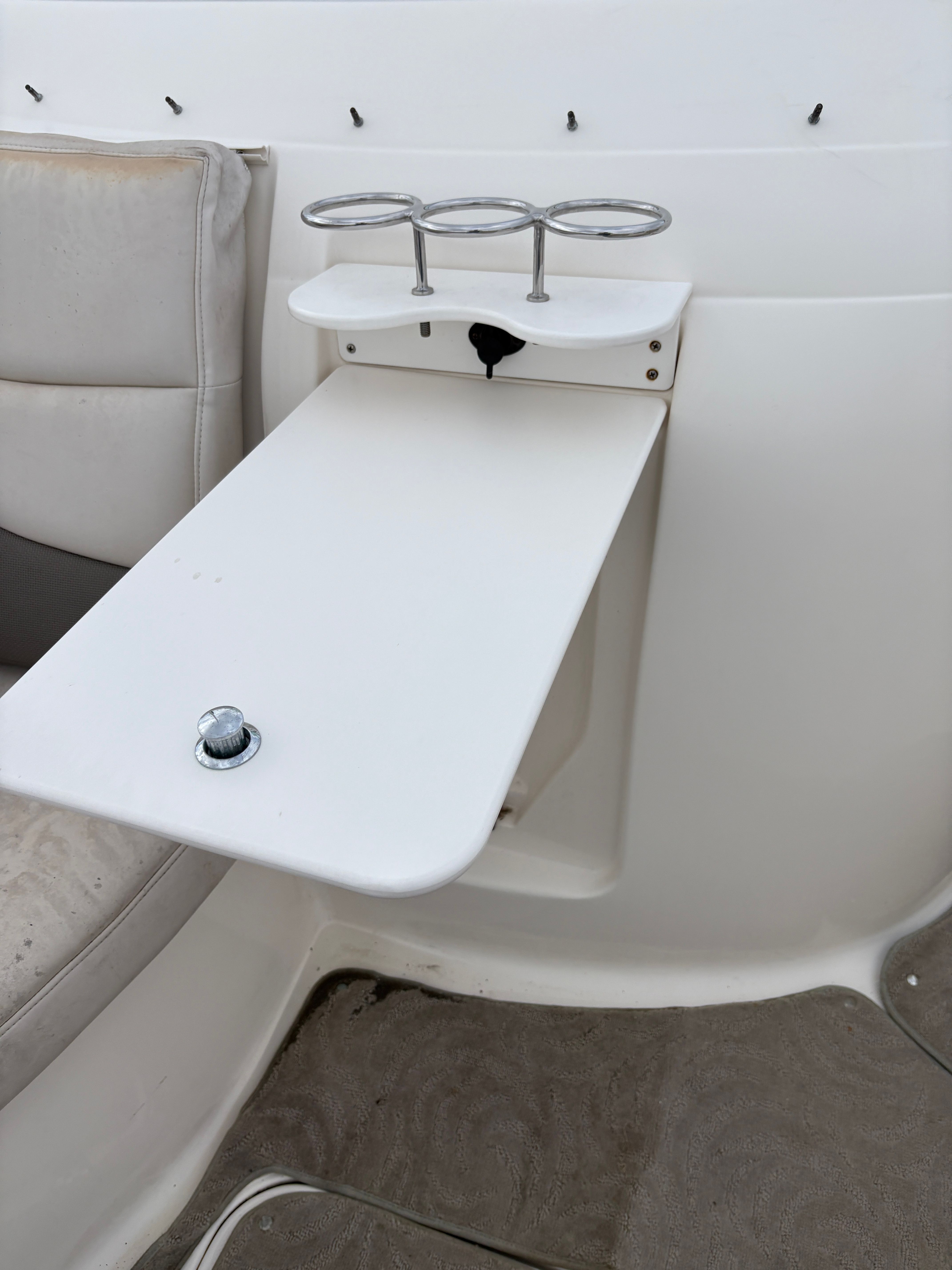 Interior of 2009 Hurricane SUN DECK 260 with table and cup holders.