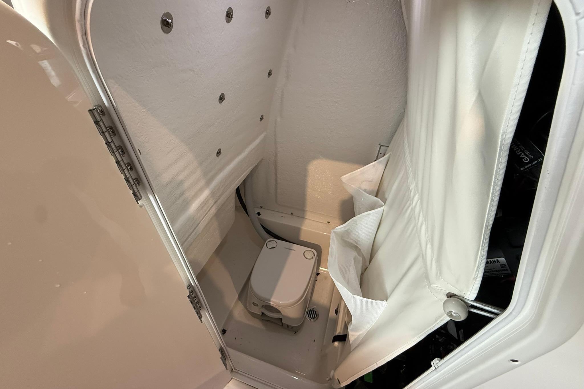 Interior of 2026 Key West 249 FS boat, featuring compact marine toilet.
