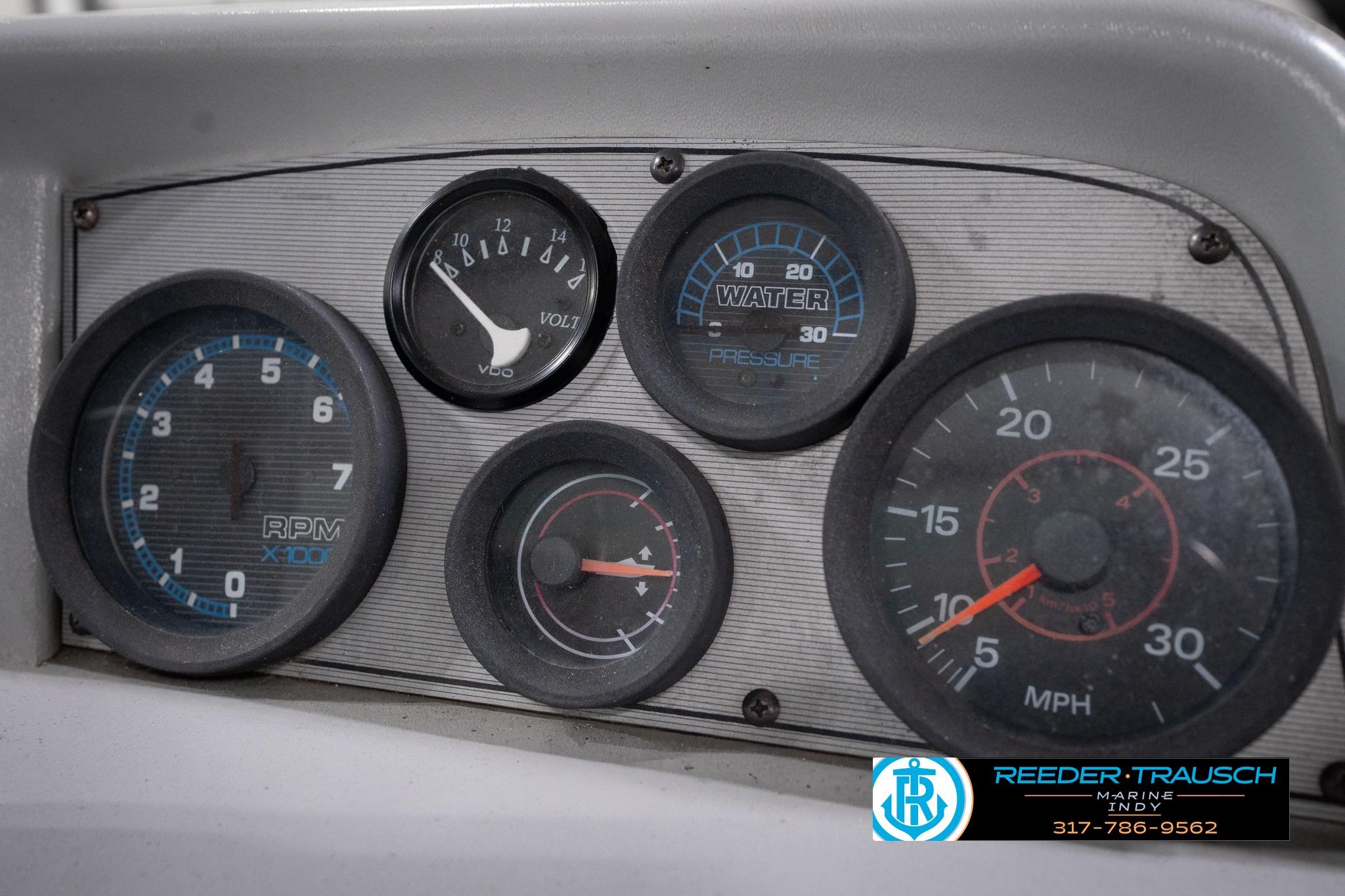 Dashboard of a 1992 Godfrey Sweetwater boat with various gauges and dials.